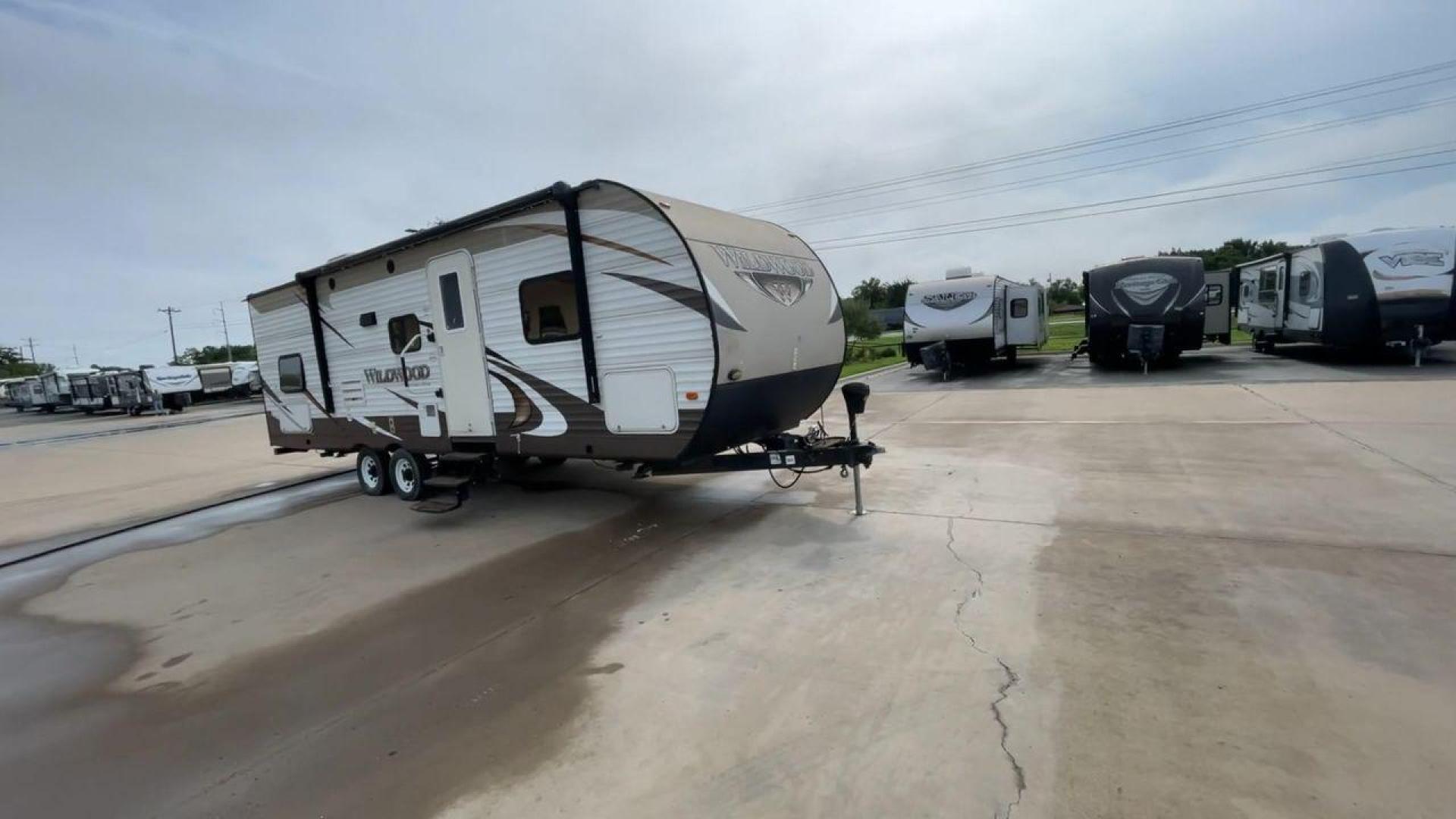 2016 WHITE FOREST RIVER WILDWOOD 28DBUD (4X4TWDD25GA) , Length: 29.83 ft. | Dry Weight: 5,847 lbs. | Slides: 1 transmission, located at 4319 N Main St, Cleburne, TX, 76033, (817) 678-5133, 32.385960, -97.391212 - This 2016 Forest River Wildwood 28DBUD measures just a bit under 30 ft. in length. It has a dry weight of 5,847 lbs. and a payload capacity of 1,920 lbs. It is a dual-axle steel wheel set-up with 1 power-retractable slide and a 16-foot power-retractable awning. Inside, you will find a spacious m - Photo#3