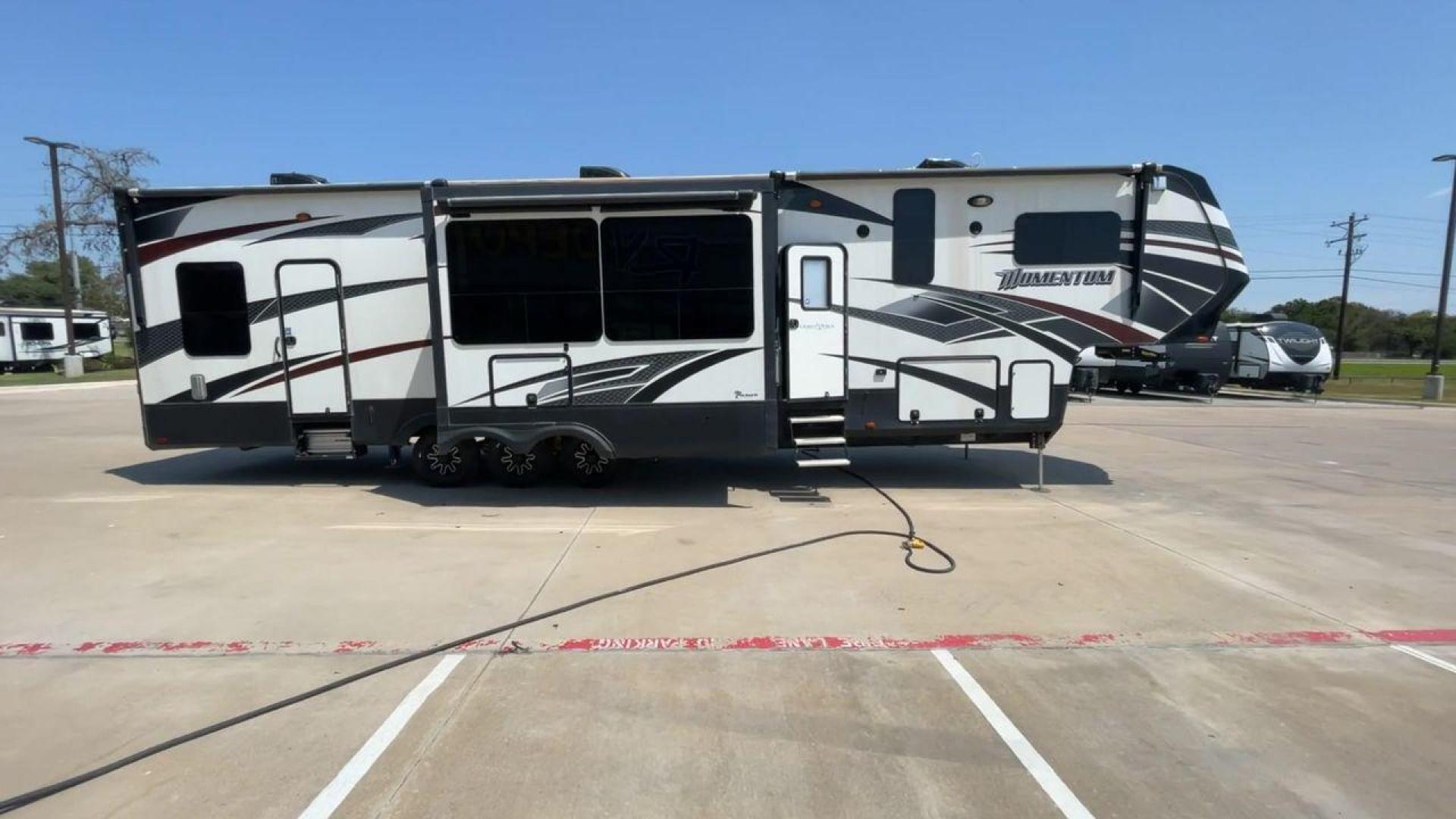 2016 GRAND DESIGN MOMENTUM 397TH (573FM4530G1) , Length: 43.25 ft. | Dry Weight: 15,500 lbs. | Gross Weight: 19,500 lbs. | Slides: 3 transmission, located at 4319 N Main St, Cleburne, TX, 76033, (817) 678-5133, 32.385960, -97.391212 - Photo#2