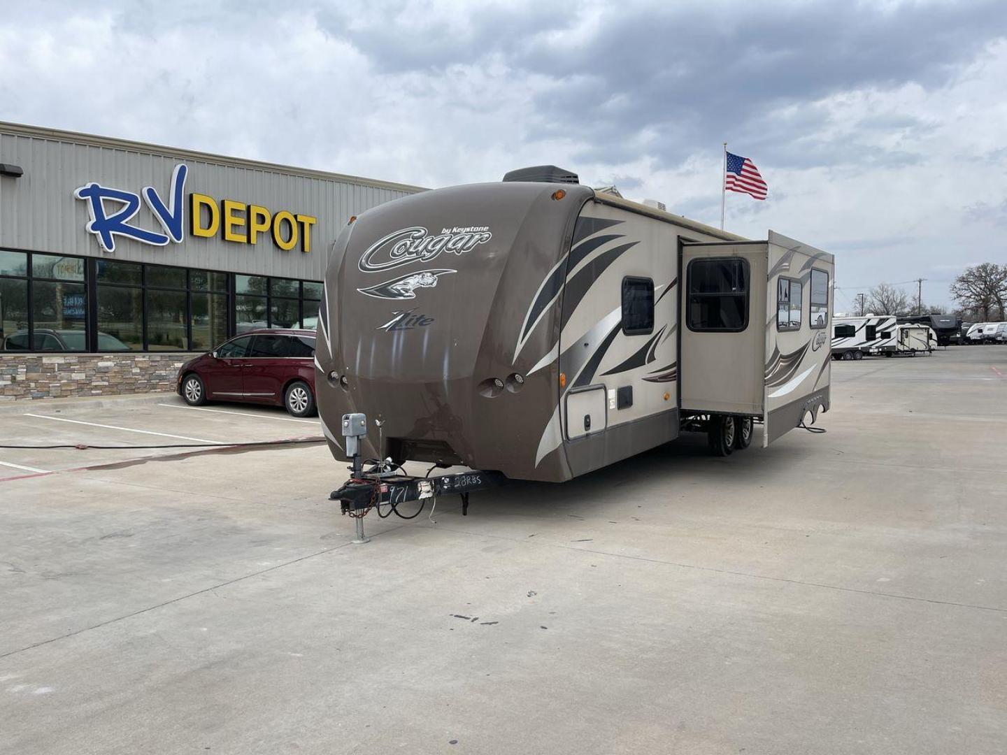 2016 BROWN KEYSTONE COUGAR 28RBS - (4YDT28R23GV) , Length: 32.17 ft. | Dry Weight: 6,115 lbs. | Gross Weight: 8,200 lbs. | Slides: 1 transmission, located at 4319 N Main St, Cleburne, TX, 76033, (817) 678-5133, 32.385960, -97.391212 - Photo#0