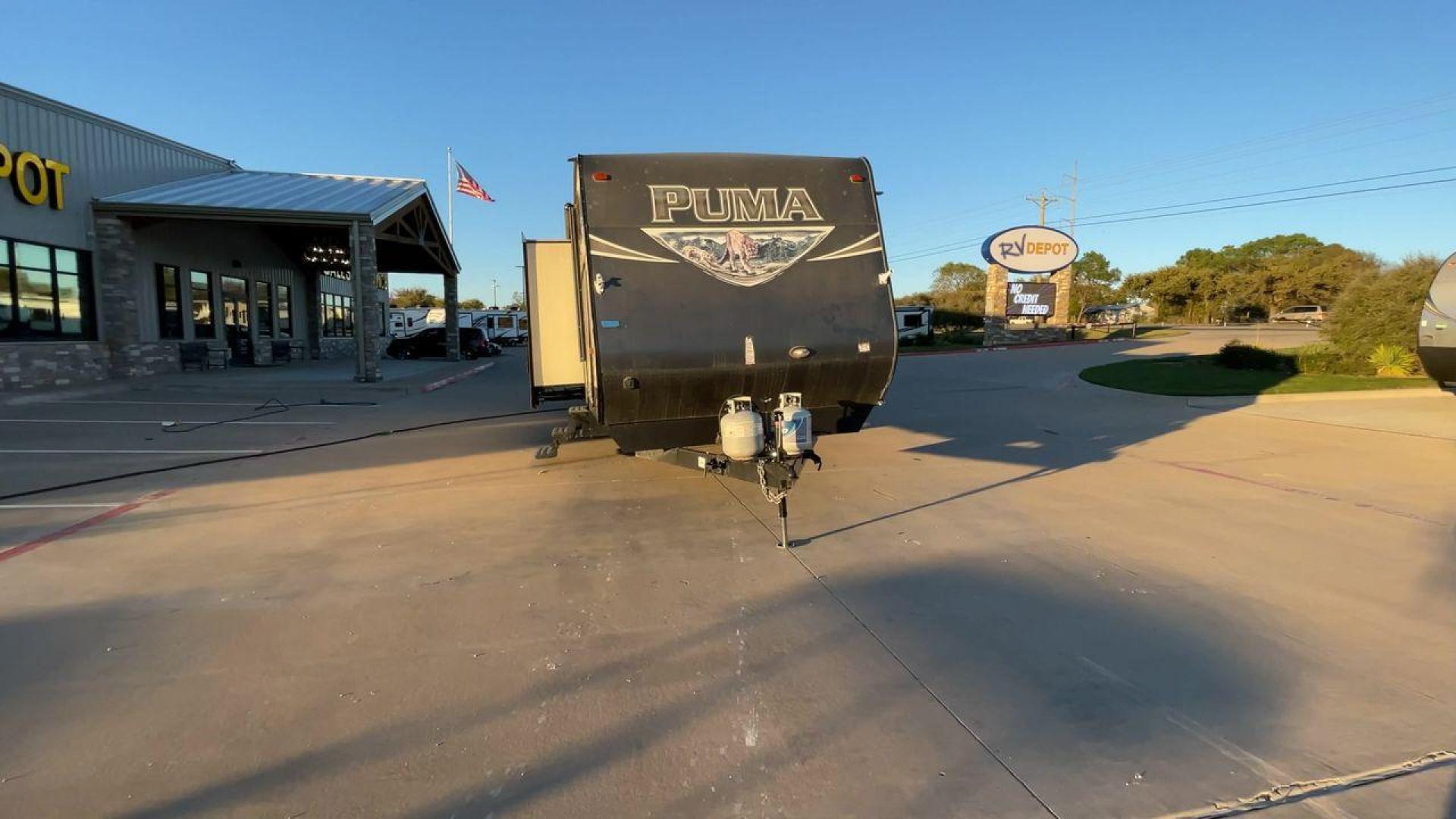 2016 TAN PUMA 32FBIS (4X4TPUH21GP) , Length: 35.33 ft. | Dry Weight: 8,858 lbs. | Gross Weight: 10,500 lbs. | Slides: 3 transmission, located at 4319 N Main St, Cleburne, TX, 76033, (817) 678-5133, 32.385960, -97.391212 - The 2016 Puma 32FBIS travel trailer boasts a classic yet robust exterior that embodies convenience and practicality for family trips and long getaways. The travel trailer features aluminum siding in a silver tone, accentuated with subtle brown and black graphic designs that add a sleek, modern touch - Photo#4