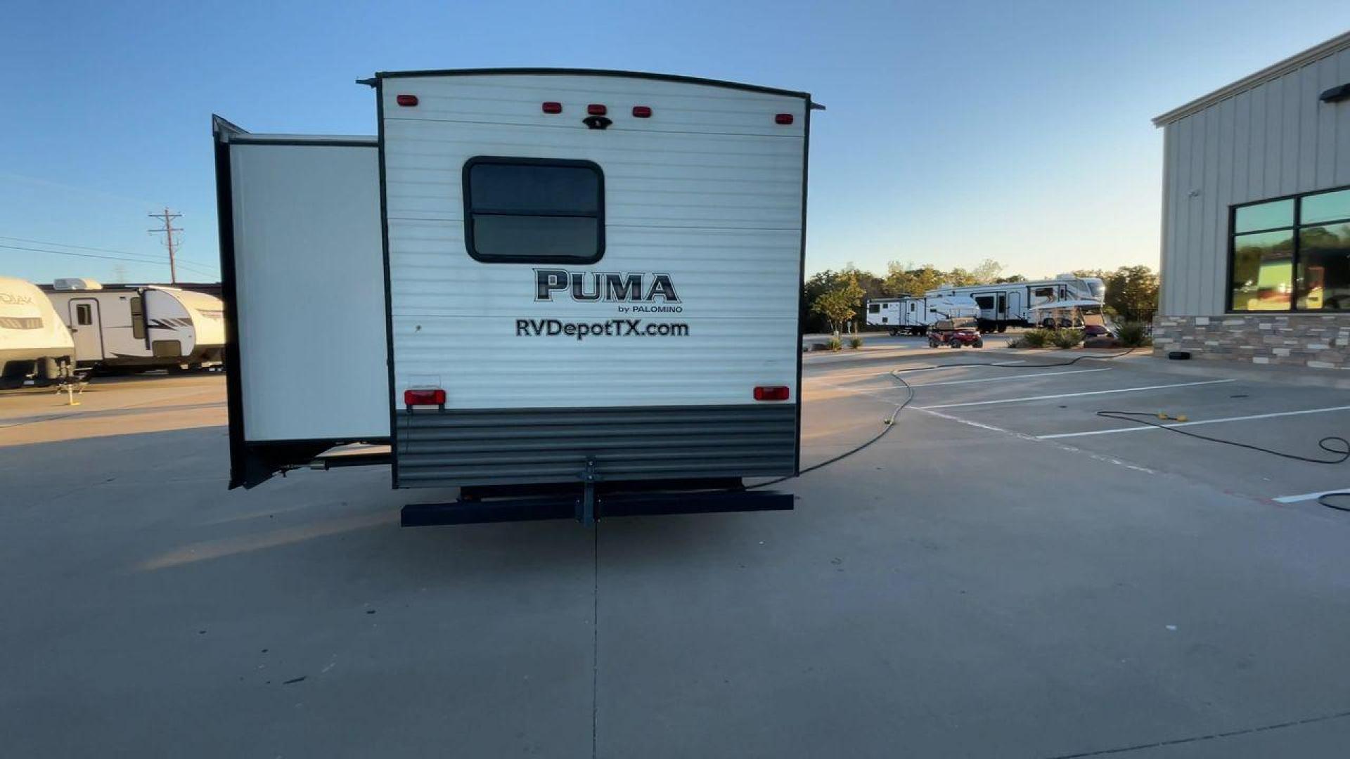 2016 TAN PUMA 32FBIS (4X4TPUH21GP) , Length: 35.33 ft. | Dry Weight: 8,858 lbs. | Gross Weight: 10,500 lbs. | Slides: 3 transmission, located at 4319 N Main St, Cleburne, TX, 76033, (817) 678-5133, 32.385960, -97.391212 - The 2016 Puma 32FBIS travel trailer boasts a classic yet robust exterior that embodies convenience and practicality for family trips and long getaways. The travel trailer features aluminum siding in a silver tone, accentuated with subtle brown and black graphic designs that add a sleek, modern touch - Photo#8