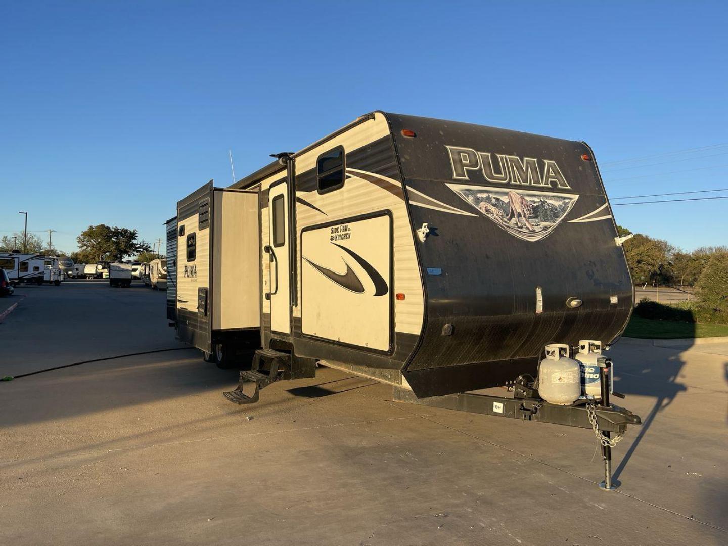 2016 TAN PUMA 32FBIS (4X4TPUH21GP) , Length: 35.33 ft. | Dry Weight: 8,858 lbs. | Gross Weight: 10,500 lbs. | Slides: 3 transmission, located at 4319 N Main St, Cleburne, TX, 76033, (817) 678-5133, 32.385960, -97.391212 - The 2016 Puma 32FBIS travel trailer boasts a classic yet robust exterior that embodies convenience and practicality for family trips and long getaways. The travel trailer features aluminum siding in a silver tone, accentuated with subtle brown and black graphic designs that add a sleek, modern touch - Photo#21