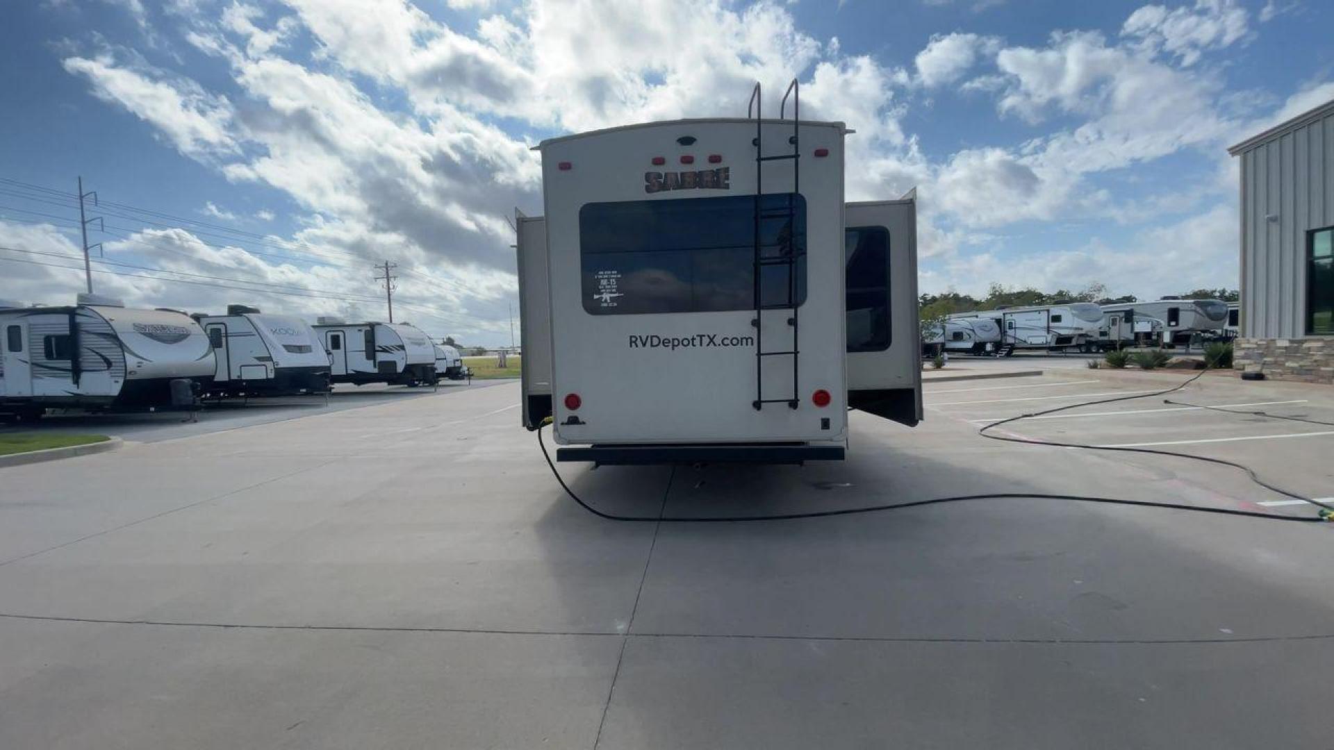 2016 TAN SABRE 365MB (4X4FSRN29G3) , Length: 42.42 ft. | Dry Weight: 12,994 lbs. | Gross Weight: 15,500 lbs. | Slides: 4 transmission, located at 4319 N Main St, Cleburne, TX, 76033, (817) 678-5133, 32.385960, -97.391212 - The 2016 Sabre 365MB Fifth Wheel stretches 42.42 feet in length, with a commanding presence on the road and at the campground. The exterior is finished in a beige and black color scheme, accented with bold swooping graphics that add an athletic flair to its overall look. The side profile features fo - Photo#8