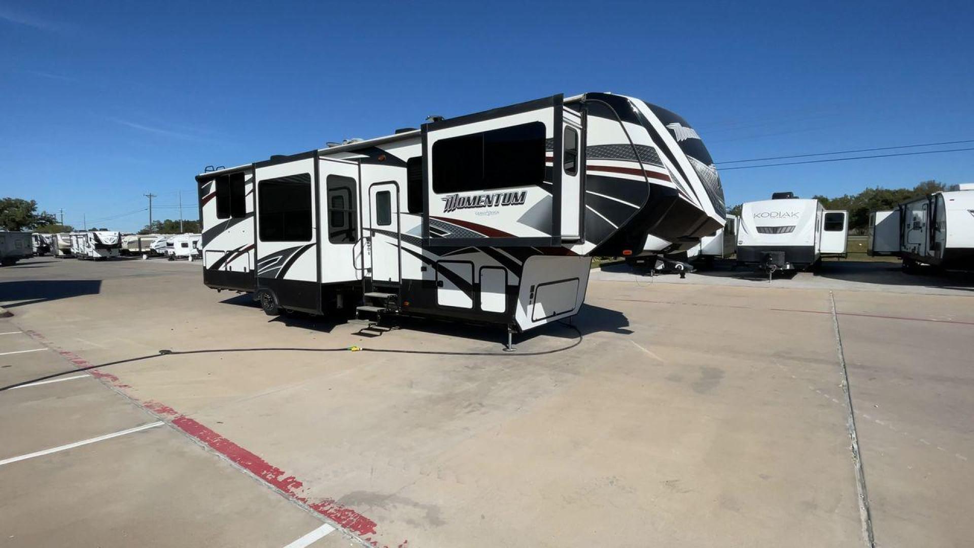 2017 GRAND DESIGN MOMENTUM 376TH (573FM4330H1) , Length: 41.25 ft. | Dry Weight: 15,900 lbs. | Gross Weight: 20,000 lbs. | Slides: 5 transmission, located at 4319 N Main St, Cleburne, TX, 76033, (817) 678-5133, 32.385960, -97.391212 - The 2017 Grand Design Momentum 376TH is a spacious fifth wheel. It measures 41.25 feet in length and built for comfort and convenience. With a dry weight of 15,900 lbs and a gross weight capacity of 20,000 lbs, this RV is sturdy and ready for adventure. It features five slide-outs, providing ample l - Photo#3