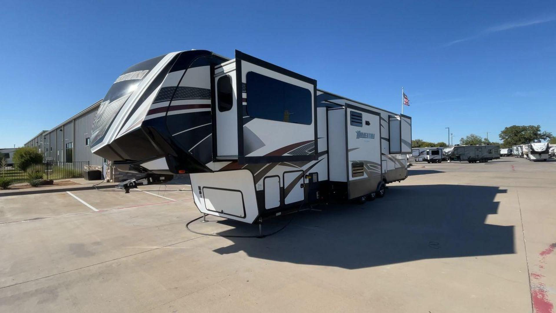 2017 GRAND DESIGN MOMENTUM 376TH (573FM4330H1) , Length: 41.25 ft. | Dry Weight: 15,900 lbs. | Gross Weight: 20,000 lbs. | Slides: 5 transmission, located at 4319 N Main St, Cleburne, TX, 76033, (817) 678-5133, 32.385960, -97.391212 - The 2017 Grand Design Momentum 376TH is a spacious fifth wheel. It measures 41.25 feet in length and built for comfort and convenience. With a dry weight of 15,900 lbs and a gross weight capacity of 20,000 lbs, this RV is sturdy and ready for adventure. It features five slide-outs, providing ample l - Photo#5