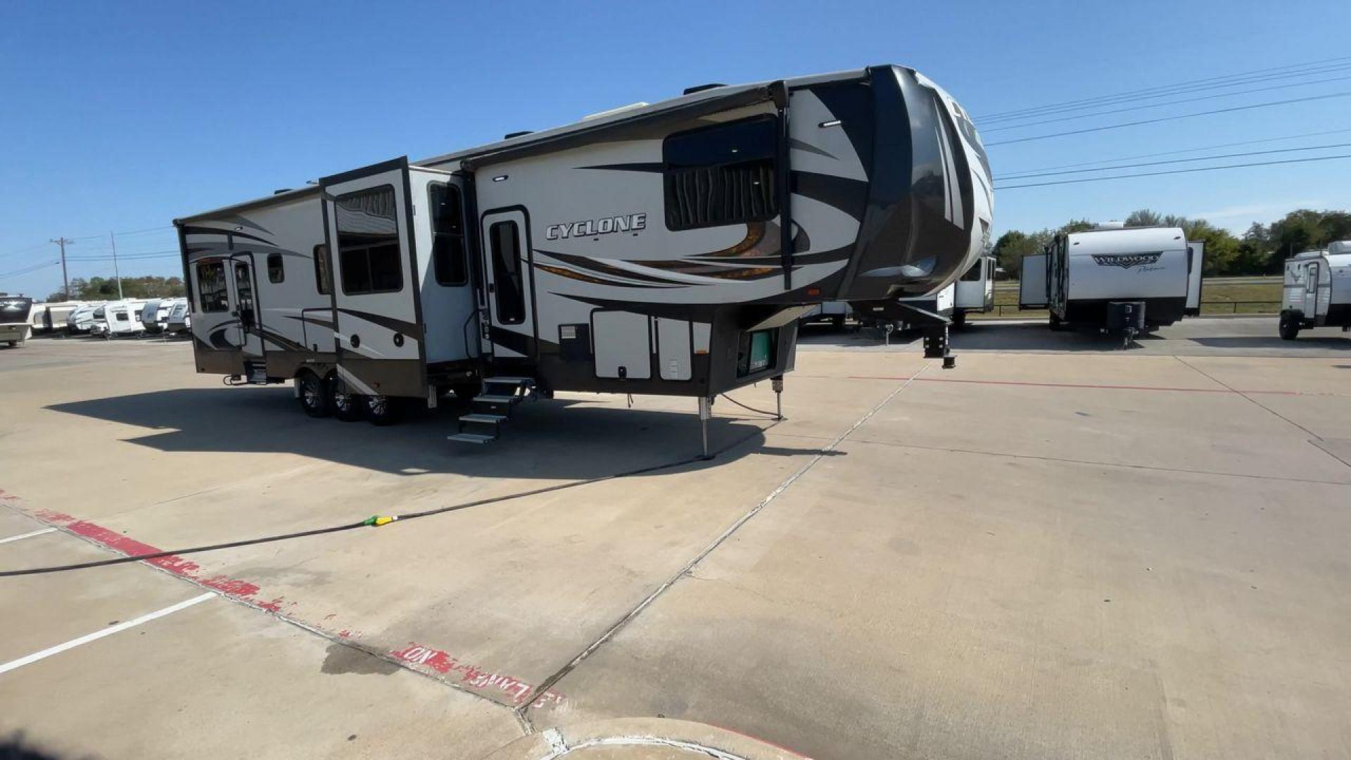 2017 HEARTLAND CYCLONE 4005 (5SFCG4434HE) , Length: 44.1 ft. | Dry Weight: 16,290 lbs.| Gross Weight: 20,000 lbs. | Slides: 3 transmission, located at 4319 N Main St, Cleburne, TX, 76033, (817) 678-5133, 32.385960, -97.391212 - The 2017 Heartland Cyclone 4005 is a luxury fifth-wheel toy hauler that combines comfort and functionality for adventurers who want the flexibility to bring toys along for the ride. Known for its spacious garage, upscale living area, and ample sleeping options, this model is ideal for thrill-seekers - Photo#3