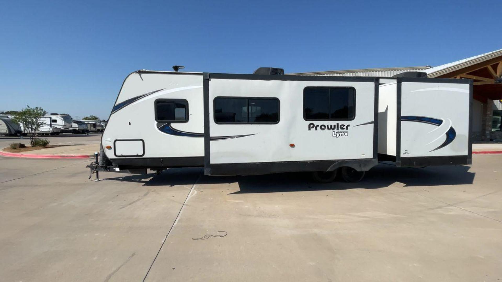 2017 HEARTLAND PROWLER 32LX (5SFPB3622JE) , Length: 36.4 ft. | Dry Weight: 7,880 lbs | Gross Weight: 9,000 lbs | Slides: 2 transmission, located at 4319 N Main St, Cleburne, TX, 76033, (817) 678-5133, 32.385960, -97.391212 - The 2017 Heartland Prowler 32LX travel trailer has dimensions of 36.4 ft in length, 8 ft width, 11.2 ft height, and 6.8 ft interior height. It has a base weight of 7,880 lbs with a 9,000 lbs GVWR and a carrying capacity of 1,120 lbs. This unit highlights an outdoor kitchen, a rear bunkhouse, a p - Photo#6