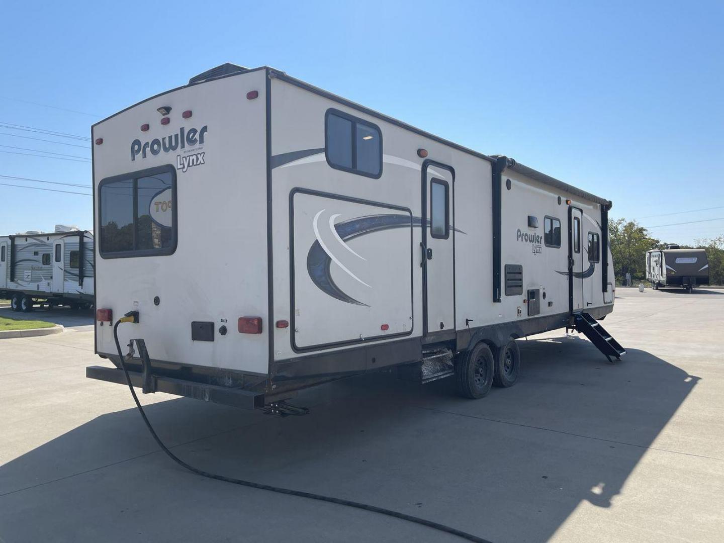 2017 HEARTLAND PROWLER 32LX (5SFPB3622JE) , Length: 36.4 ft. | Dry Weight: 7,880 lbs | Gross Weight: 9,000 lbs | Slides: 2 transmission, located at 4319 N Main St, Cleburne, TX, 76033, (817) 678-5133, 32.385960, -97.391212 - The 2017 Heartland Prowler 32LX travel trailer has dimensions of 36.4 ft in length, 8 ft width, 11.2 ft height, and 6.8 ft interior height. It has a base weight of 7,880 lbs with a 9,000 lbs GVWR and a carrying capacity of 1,120 lbs. This unit highlights an outdoor kitchen, a rear bunkhouse, a p - Photo#25