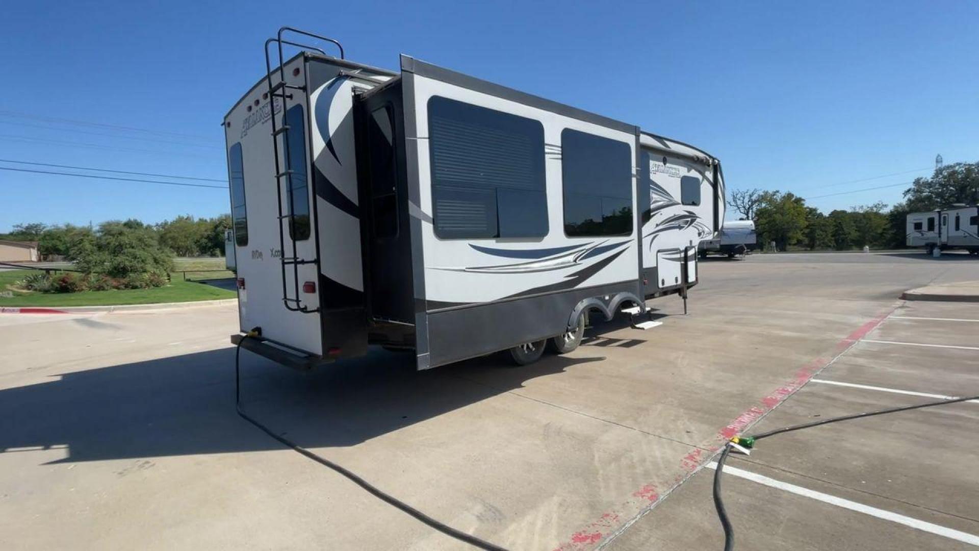 2017 GRAY KEYSTONE AVALANCHE 300RE (4YDF30028HE) , Length: 34.5 ft. | Dry Weight: 11,489 lbs. | Gross Weight: 15,000 lbs. | Slides: 3 transmission, located at 4319 N Main St, Cleburne, TX, 76033, (817) 678-5133, 32.385960, -97.391212 - The 2017 Keystone Avalanche 300RE is a dual-axle aluminum wheel setup measuring 34.5 ft. in length. It has a dry weight of 11,489 lbs. and a GVWR of 15,000 lbs. Its exterior is a base color of silver with black, gray, and white graphics. It is made of aluminum and fiberglass. With 3 slides, it is ro - Photo#1