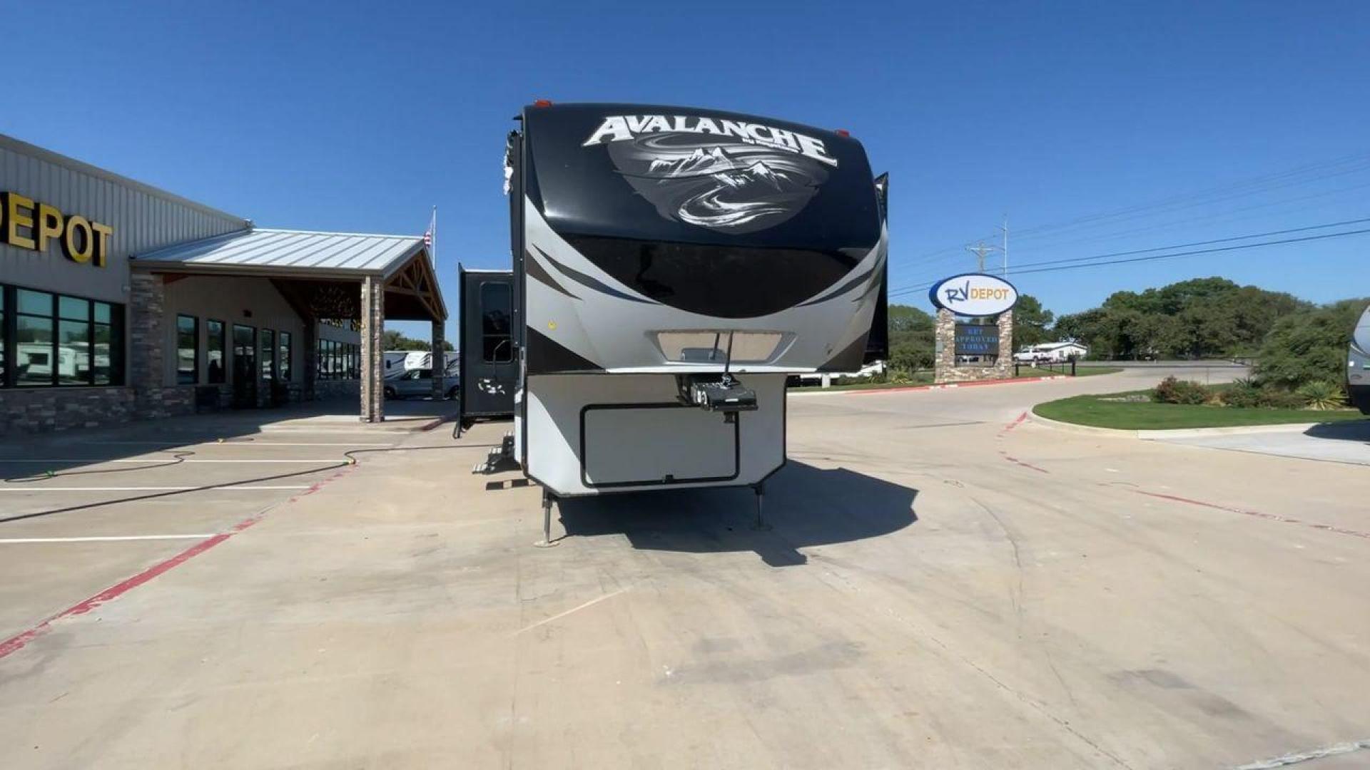 2017 GRAY KEYSTONE AVALANCHE 300RE (4YDF30028HE) , Length: 34.5 ft. | Dry Weight: 11,489 lbs. | Gross Weight: 15,000 lbs. | Slides: 3 transmission, located at 4319 N Main St, Cleburne, TX, 76033, (817) 678-5133, 32.385960, -97.391212 - The 2017 Keystone Avalanche 300RE is a dual-axle aluminum wheel setup measuring 34.5 ft. in length. It has a dry weight of 11,489 lbs. and a GVWR of 15,000 lbs. Its exterior is a base color of silver with black, gray, and white graphics. It is made of aluminum and fiberglass. With 3 slides, it is ro - Photo#4