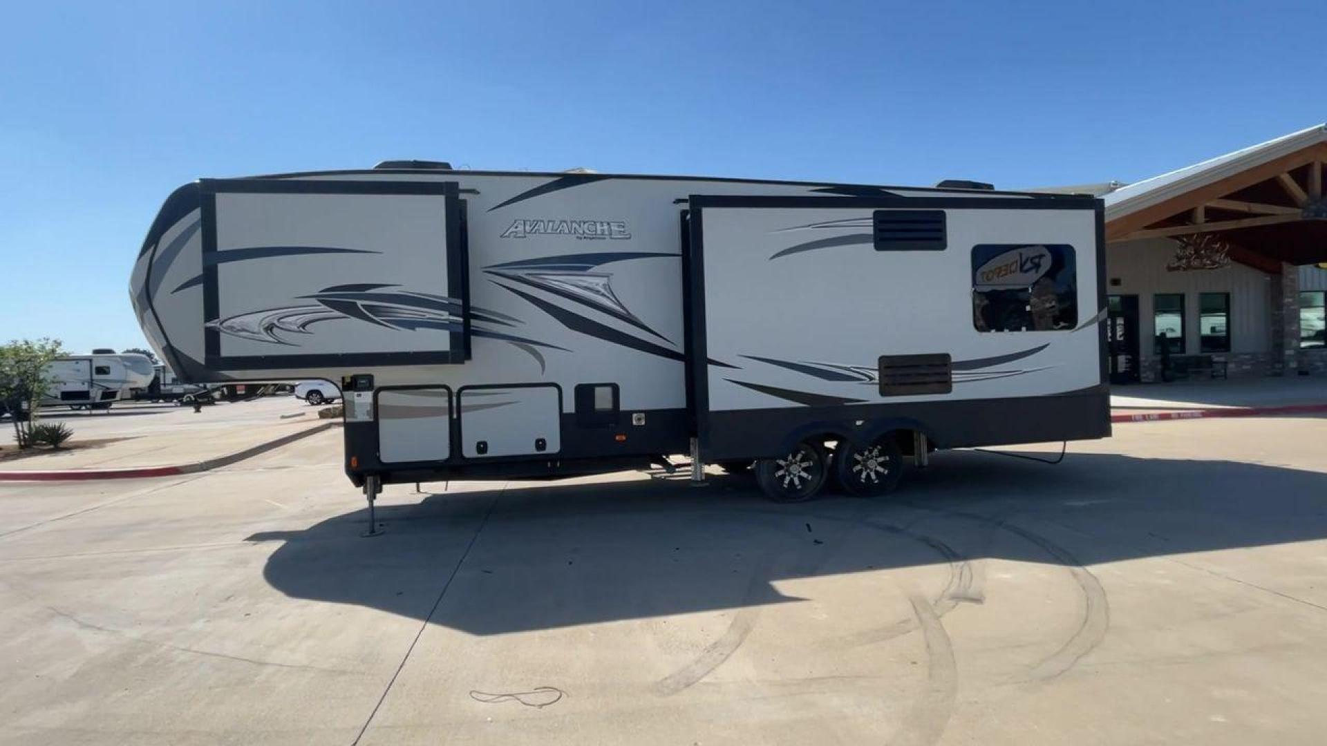 2017 GRAY KEYSTONE AVALANCHE 300RE (4YDF30028HE) , Length: 34.5 ft. | Dry Weight: 11,489 lbs. | Gross Weight: 15,000 lbs. | Slides: 3 transmission, located at 4319 N Main St, Cleburne, TX, 76033, (817) 678-5133, 32.385960, -97.391212 - The 2017 Keystone Avalanche 300RE is a dual-axle aluminum wheel setup measuring 34.5 ft. in length. It has a dry weight of 11,489 lbs. and a GVWR of 15,000 lbs. Its exterior is a base color of silver with black, gray, and white graphics. It is made of aluminum and fiberglass. With 3 slides, it is ro - Photo#6