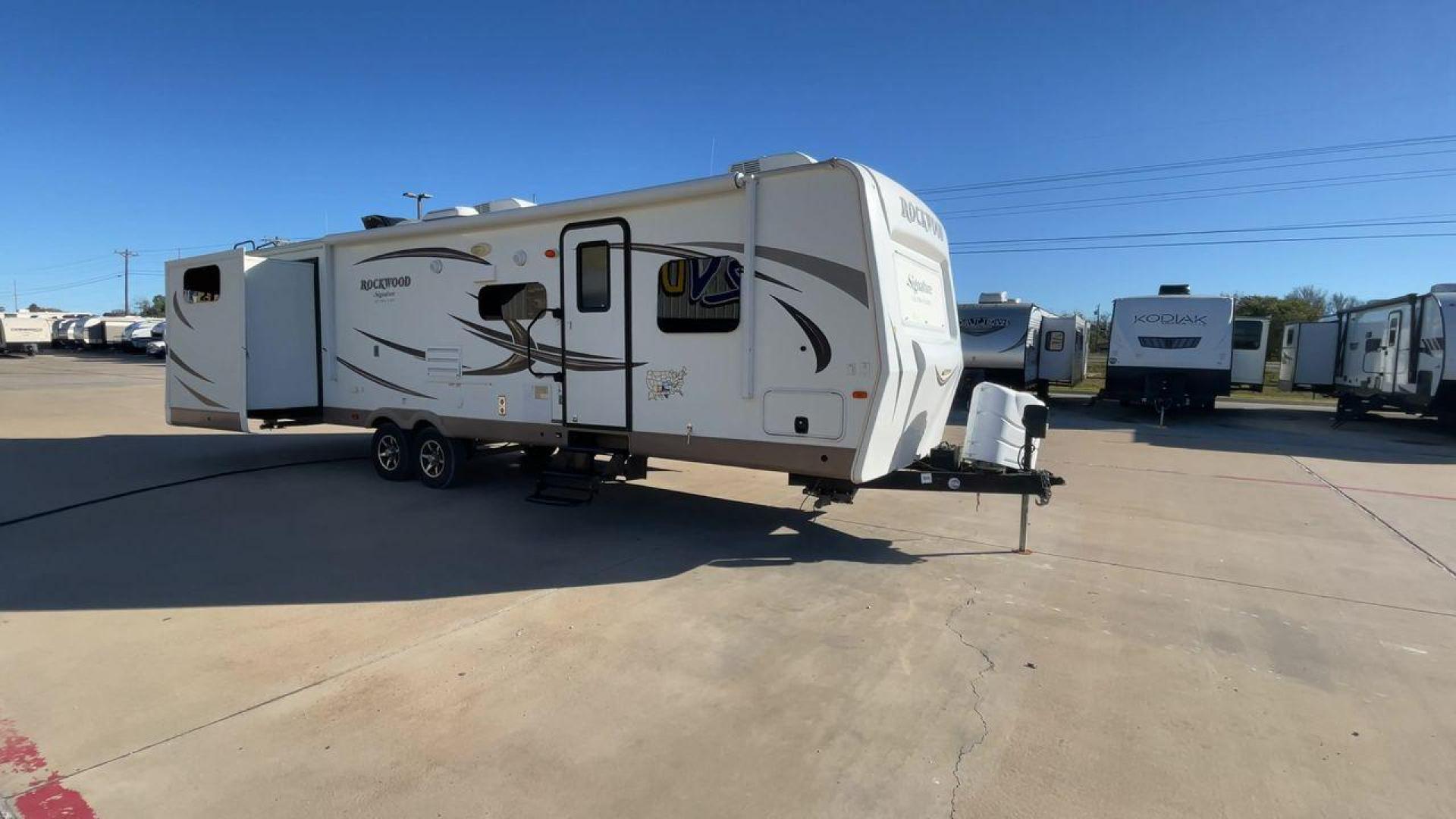 2017 TAN ROCKWOOD 8326BHS - (4X4TRLJ28H1) , Length: 35.42 ft. | Dry Weight: 8,363 lbs. | Slides: 4 transmission, located at 4319 N Main St, Cleburne, TX, 76033, (817) 678-5133, 32.385960, -97.391212 - The 2017 Rockwood 8326BHS travel trailer offers a clean white body with attractive brown and black graphics. It has four slideouts that significantly expand the living space. These slideouts are located on both sides of the trailer, enhancing the overall size and usability of the interior. At the fr - Photo#3