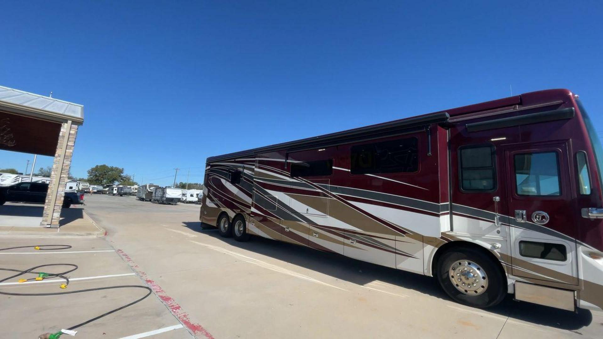 2017 TIFFIN ALLEGRO BUS 45OPP (5VBBAK7A6HA) , Length: 45 ft | Gross Weight: 51,000 lbs | Slides: 4 transmission, located at 4319 N Main St, Cleburne, TX, 76033, (817) 678-5133, 32.385960, -97.391212 - The 2017 TIFFIN ALLEGRO BUS 45OPP features a luxurious exterior with a striking maroon, white, and beige paint scheme. The large, sleek side panels are accentuated by elegant, sweeping graphics, giving it an upscale, eye-catching look. The motorhome is built on a spacious chassis, with a prominent f - Photo#3