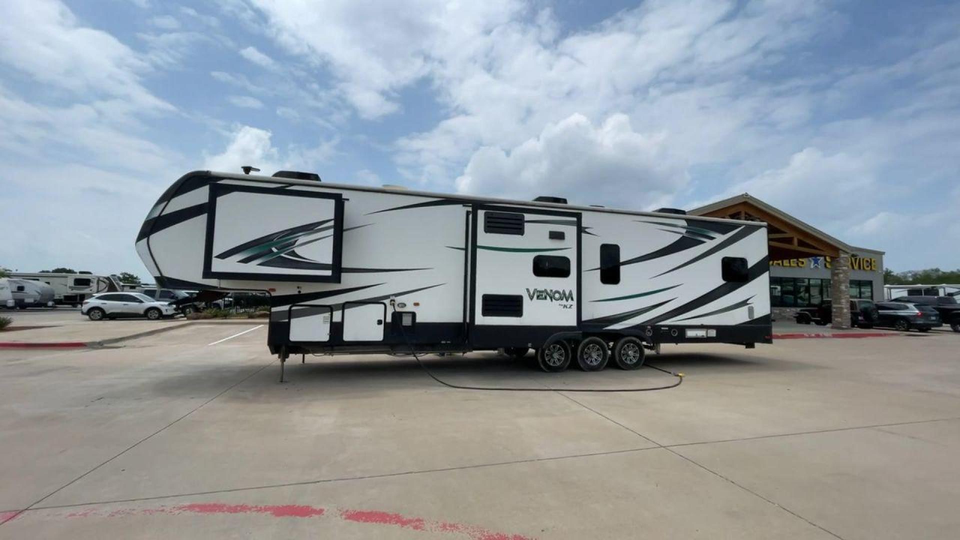 2017 BLACK VENOM 4013TK - (4EZFH4039H6) , Length: 43.33 ft. | Dry Weight: 14,760 lbs. | Gross Weight: 19,000 lbs. | Slides: 3 transmission, located at 4319 N Main St, Cleburne, TX, 76033, (817) 678-5133, 32.385960, -97.391212 - With the 2017 Venom 4013TK, you can enjoy the highest level of luxury and usefulness. This impressive fifth wheel is 43.33 feet long, so it has plenty of room for your living space and storage for all your camping stuff. It is the right mix of strength and ease of towing, with a dry weight of 14,760 - Photo#0