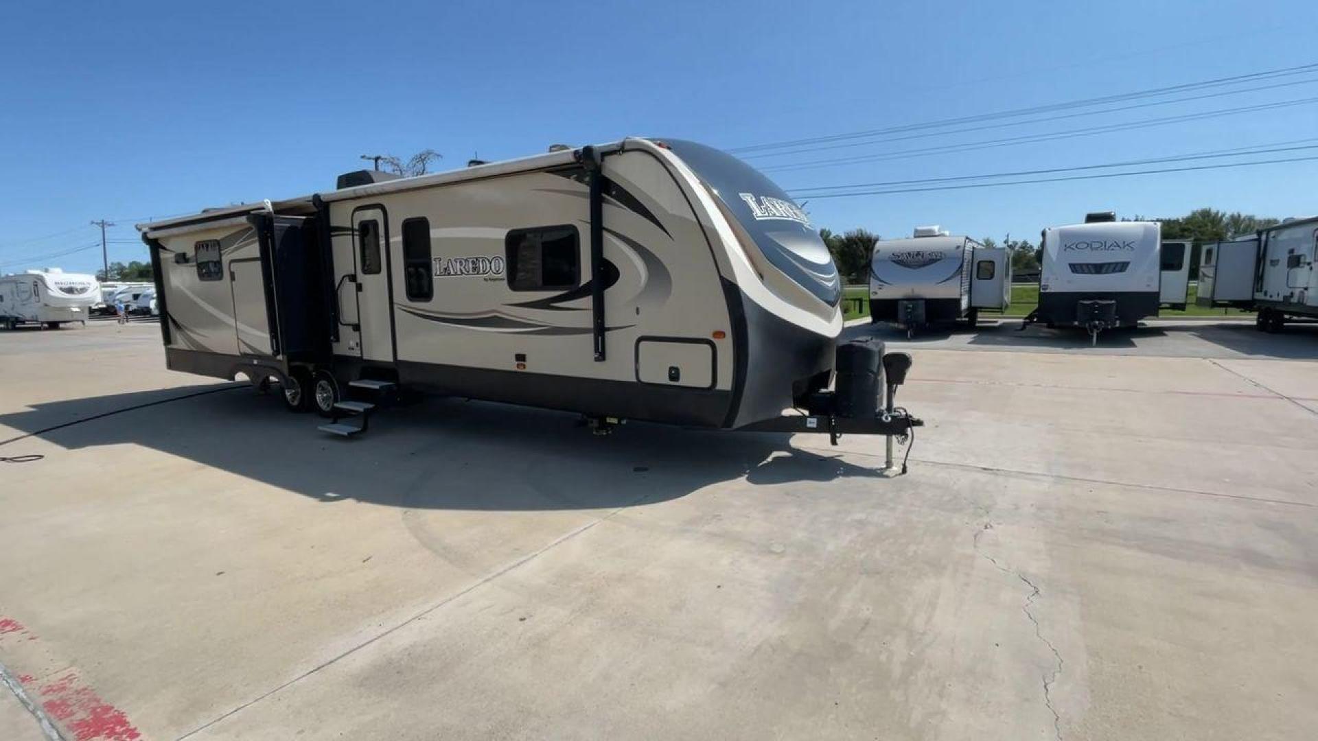 2018 KEYSTONE LAREDO 335MK (4YDT33524JV) , Length: 37.92 ft. | Dry Weight: 8,473 lbs. | Gross Weight: 10,000 lbs. | Slides: 2 transmission, located at 4319 N Main St, Cleburne, TX, 76033, (817) 678-5133, 32.385960, -97.391212 - The 2018 Keystone Laredo 335MK is a spacious and feature-packed travel trailer with a length of 37.92 ft, a dry weight of 8,473 lbs, and a gross weight capacity of 10,000 lbs. It includes two large slide-outs, significantly expanding the living and kitchen areas. The exterior features a cream and be - Photo#3