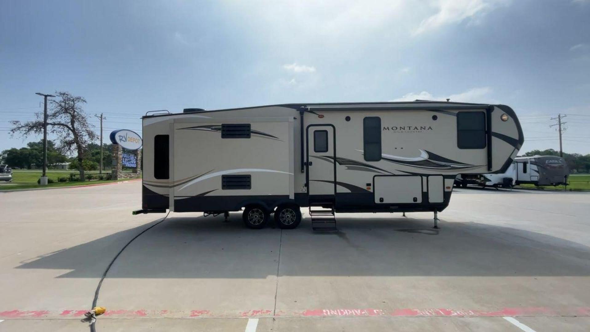 2018 TAN KEYSTONE MONTANA 305RL (4YDF3052XJA) , Length: 35.67 ft. | Dry Weight: 10,390 lbs. | Gross Weight: 14,270 lbs. | Slides: 3 transmission, located at 4319 N Main St, Cleburne, TX, 76033, (817) 678-5133, 32.385960, -97.391212 - The 2018 Keystone Montana 305RL is a dual-axle aluminum wheel set-up that measures 35.67 ft. in length. It has a dry weight of 10,390 lbs. and a GVWR of 14,270 lbs. It is made of aluminum and fiberglass. It comes with automatic heating and cooling rated at 35,000 and 15,000 BTUs respectively. With 3 - Photo#2