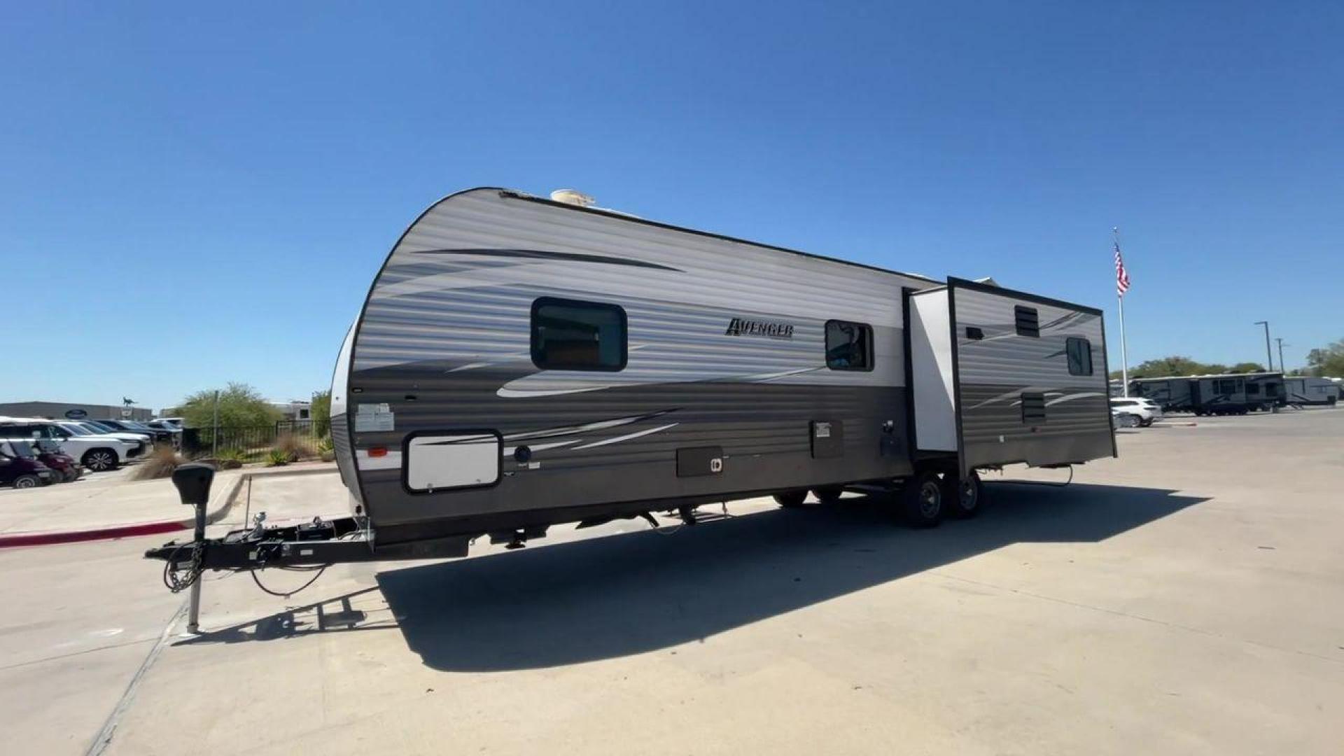 2019 TAN FOREST RIVER AVENGER 32DEN (5ZT2AVXB6KB) , Length: 37.92 ft. | Dry Weight: 7,989 lbs. | Slides: 2 transmission, located at 4319 N Main St, Cleburne, TX, 76033, (817) 678-5133, 32.385960, -97.391212 - Measuring an impressive 36 feet, this model unfolds to reveal two strategically placed slide-outs, creating a spacious haven for relaxation. The master bedroom welcomes you with a queen-size bed and ample storage, ensuring a peaceful retreat after a day of outdoor exploration. The living area is a h - Photo#5