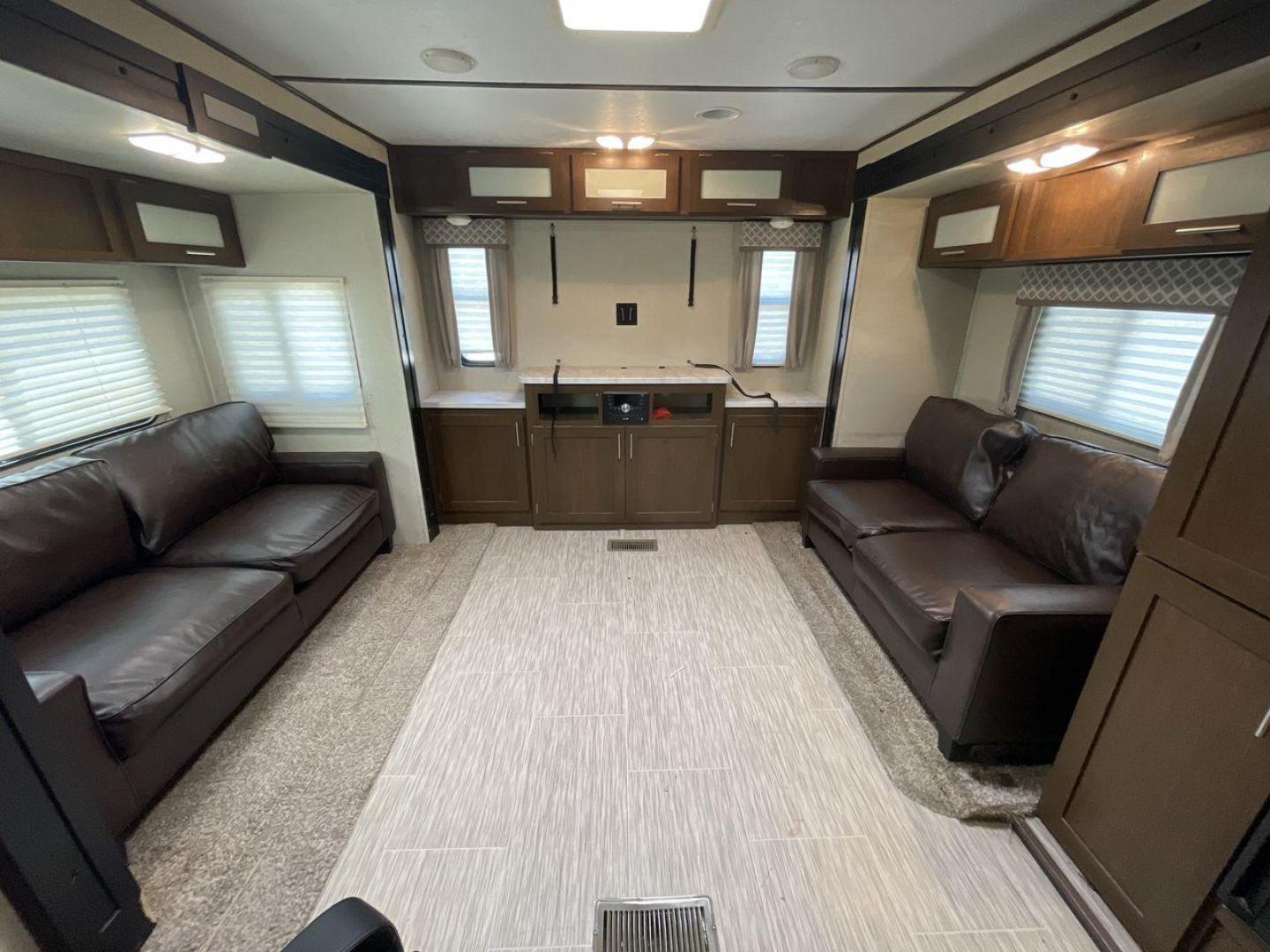 2019 TAN FOREST RIVER AVENGER 32DEN (5ZT2AVXB6KB) , Length: 37.92 ft. | Dry Weight: 7,989 lbs. | Slides: 2 transmission, located at 4319 N Main St, Cleburne, TX, 76033, (817) 678-5133, 32.385960, -97.391212 - Measuring an impressive 36 feet, this model unfolds to reveal two strategically placed slide-outs, creating a spacious haven for relaxation. The master bedroom welcomes you with a queen-size bed and ample storage, ensuring a peaceful retreat after a day of outdoor exploration. The living area is a h - Photo#11