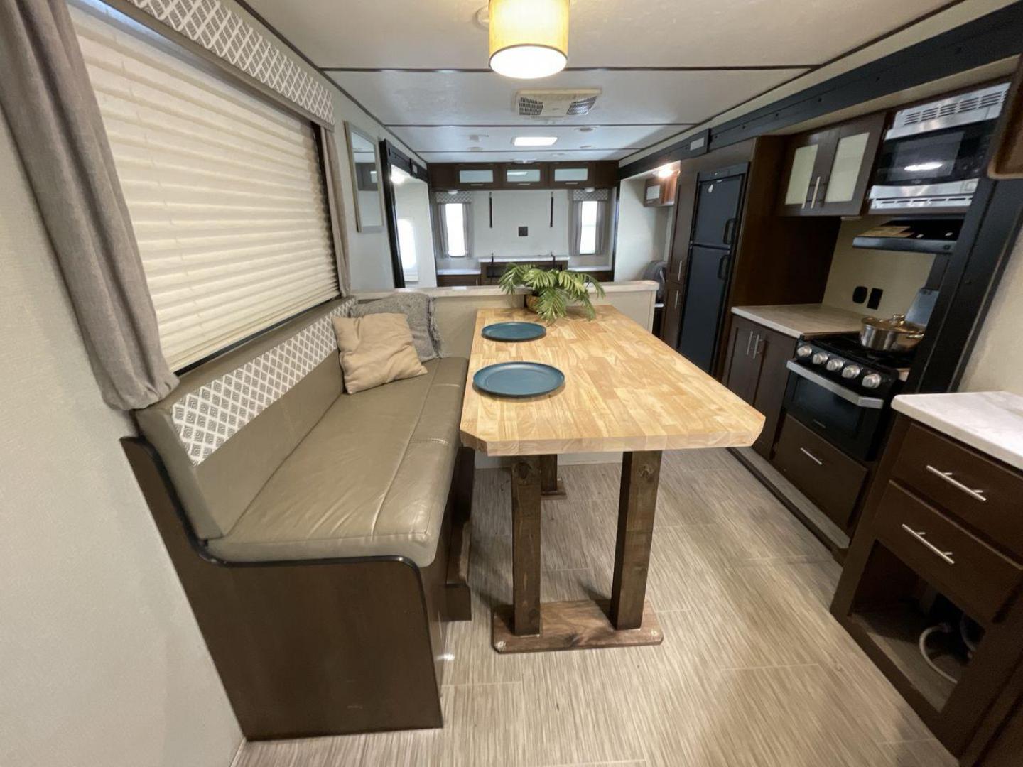 2019 TAN FOREST RIVER AVENGER 32DEN (5ZT2AVXB6KB) , Length: 37.92 ft. | Dry Weight: 7,989 lbs. | Slides: 2 transmission, located at 4319 N Main St, Cleburne, TX, 76033, (817) 678-5133, 32.385960, -97.391212 - Measuring an impressive 36 feet, this model unfolds to reveal two strategically placed slide-outs, creating a spacious haven for relaxation. The master bedroom welcomes you with a queen-size bed and ample storage, ensuring a peaceful retreat after a day of outdoor exploration. The living area is a h - Photo#13