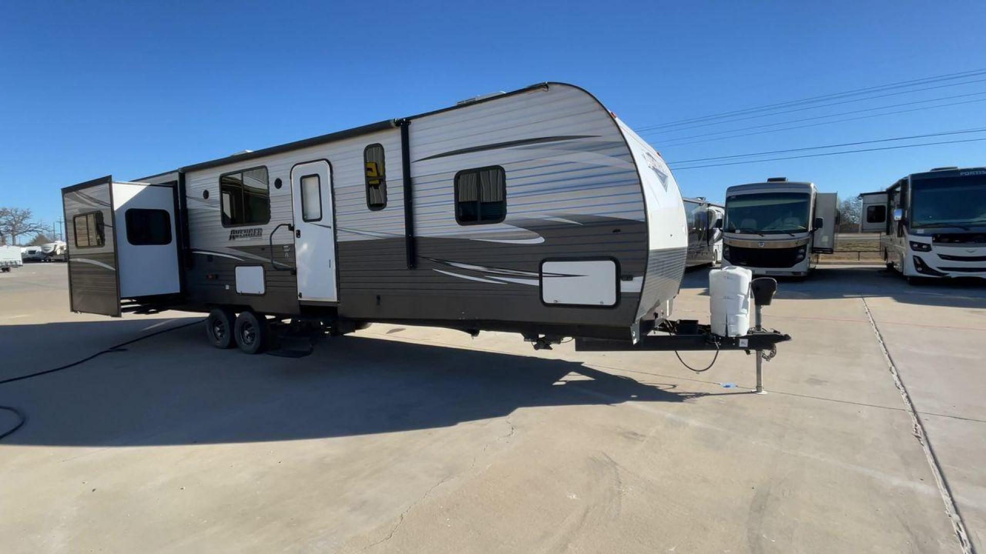 2019 TAN FOREST RIVER AVENGER 32DEN (5ZT2AVXB6KB) , Length: 37.92 ft. | Dry Weight: 7,989 lbs. | Slides: 2 transmission, located at 4319 N Main St, Cleburne, TX, 76033, (817) 678-5133, 32.385960, -97.391212 - Measuring an impressive 36 feet, this model unfolds to reveal two strategically placed slide-outs, creating a spacious haven for relaxation. The master bedroom welcomes you with a queen-size bed and ample storage, ensuring a peaceful retreat after a day of outdoor exploration. The living area is a h - Photo#3