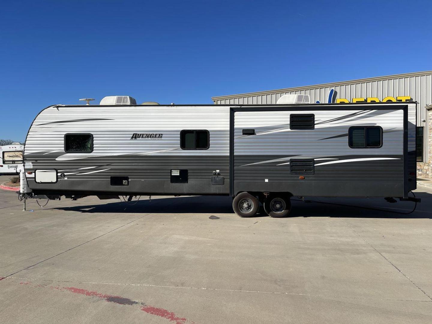 2019 TAN FOREST RIVER AVENGER 32DEN (5ZT2AVXB6KB) , Length: 37.92 ft. | Dry Weight: 7,989 lbs. | Slides: 2 transmission, located at 4319 N Main St, Cleburne, TX, 76033, (817) 678-5133, 32.385960, -97.391212 - Measuring an impressive 36 feet, this model unfolds to reveal two strategically placed slide-outs, creating a spacious haven for relaxation. The master bedroom welcomes you with a queen-size bed and ample storage, ensuring a peaceful retreat after a day of outdoor exploration. The living area is a h - Photo#24