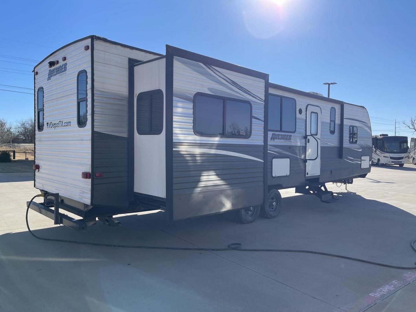 2019 TAN FOREST RIVER AVENGER 32DEN (5ZT2AVXB6KB) , Length: 37.92 ft. | Dry Weight: 7,989 lbs. | Slides: 2 transmission, located at 4319 N Main St, Cleburne, TX, 76033, (817) 678-5133, 32.385960, -97.391212 - Measuring an impressive 36 feet, this model unfolds to reveal two strategically placed slide-outs, creating a spacious haven for relaxation. The master bedroom welcomes you with a queen-size bed and ample storage, ensuring a peaceful retreat after a day of outdoor exploration. The living area is a h - Photo#25