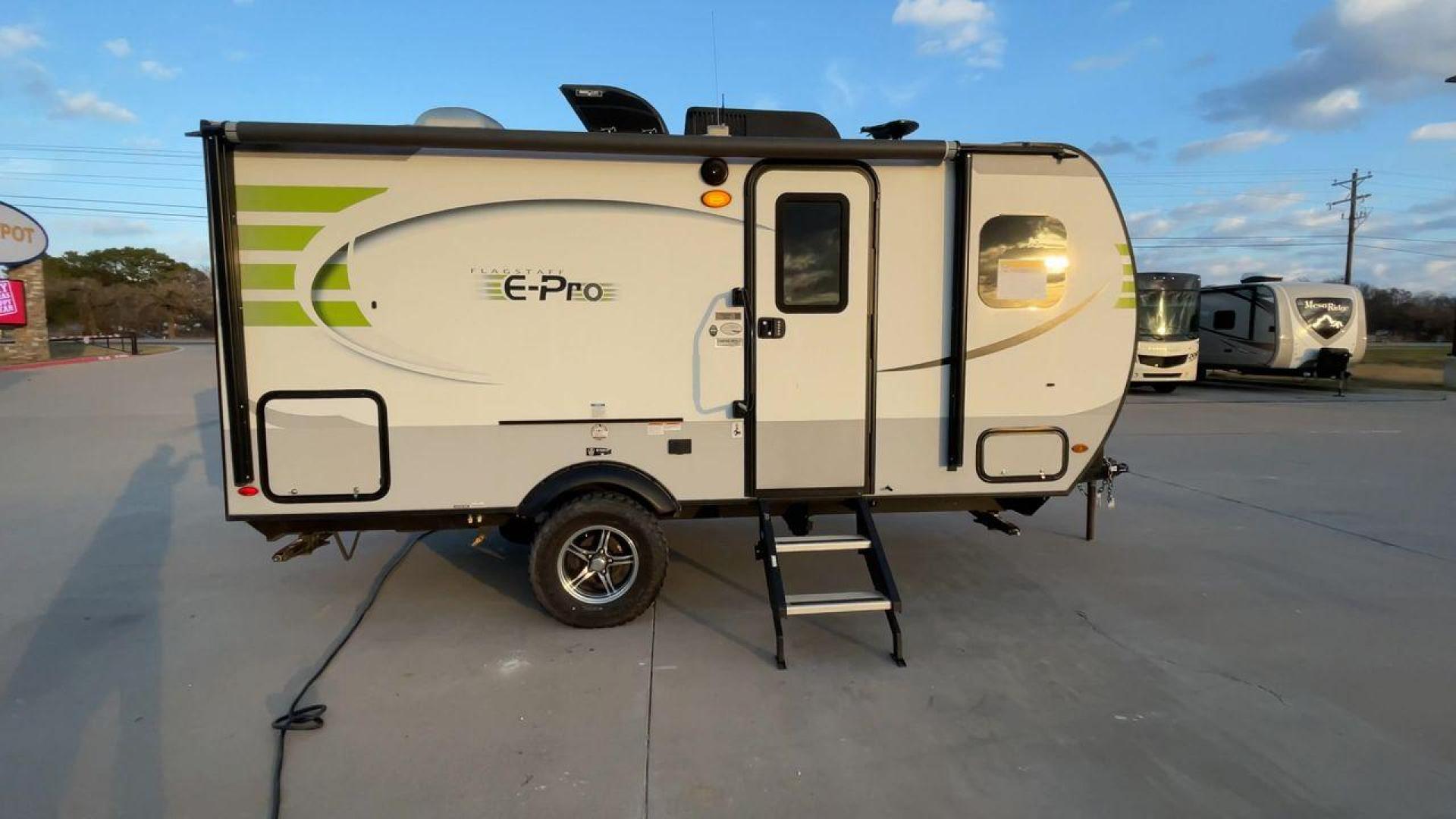 2019 FOREST RIVER FLAGSTAFF E-PRO 16BH (5ZT2FSEC3K3) , Length: 18.33 ft. | Dry Weight: 2,993 lbs. | Slides: 1 transmission, located at 4319 N Main St, Cleburne, TX, 76033, (817) 678-5133, 32.385960, -97.391212 - The 2019 Forest River Flagstaff E-Pro 16BH is a compact, lightweight travel trailer designed for adventure. Its exterior features a sleek and modern design with a white body accented by bold green graphics, giving it a fresh and sporty look. The single slide-out on the driver's side provides additio - Photo#2