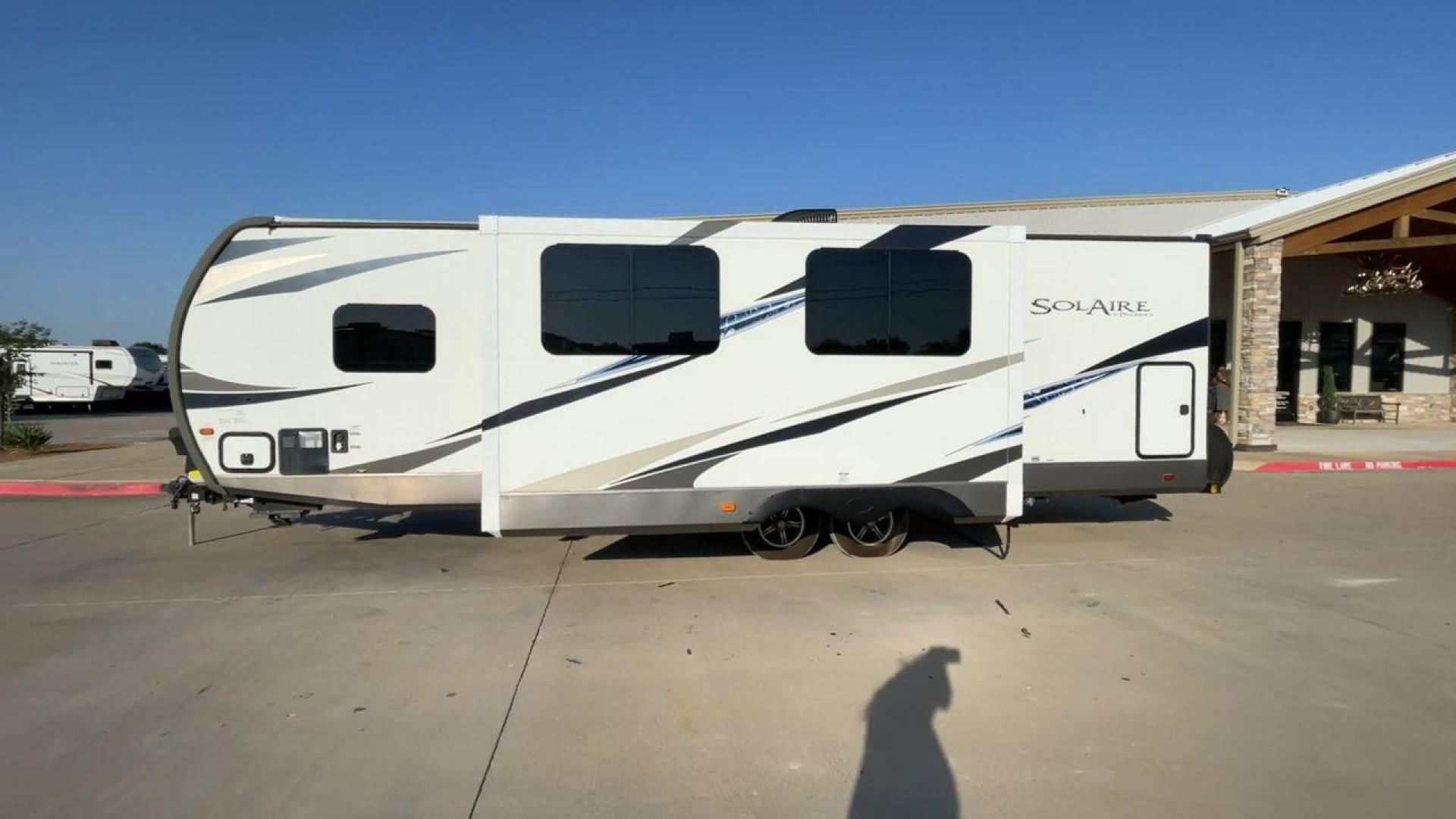 2019 TAN FOREST RIVER SOLAIRE 258RBSS (4X4TPAB24KN) , Length: 32.67 ft. | Dry Weight: 6,398 lbs. | Gross Weight: 7,765 lbs. | Slides: 1 transmission, located at 4319 N Main St, Cleburne, TX, 76033, (817) 678-5133, 32.385960, -97.391212 - The 2019 Palomino Solaire 258RBSS Travel Trailer combines style with functionality. Measuring 32.67 feet in length, this unit features a single slide-out, which provides additional interior space. The white and gray body is accented with dynamic graphics, offering a contemporary look. The front show - Photo#6