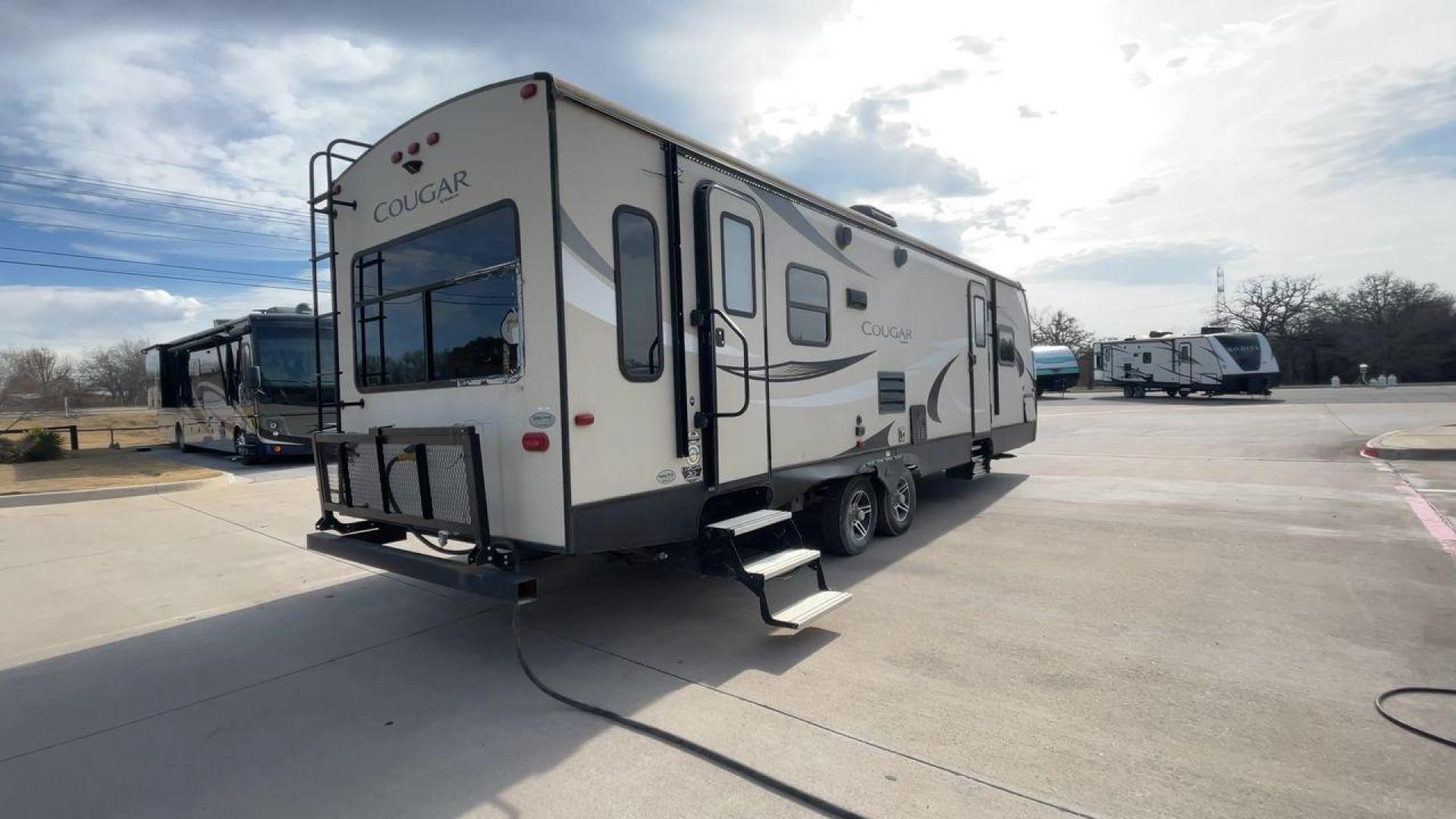 2019 TAN KEYSTONE COUGAR 29RLD (4YDT29R22JV) , Length: 34 ft. | Dry Weight: 7,380 lbs. | Gross Weight: 9,560 lbs. | Slides: 2 transmission, located at 4319 N Main St, Cleburne, TX, 76033, (817) 678-5133, 32.385960, -97.391212 - The 2019 Keystone Cougar 29RLD is a dual-axle aluminum wheel set-up measuring exactly 34 ft. in length. It has a dry weight of 7,380 lbs. and a GVWR of 9,560 lbs. Its exterior is a base color of tan with black and white accents. It comes with automatic heating and cooling rated at 35,000 and 15,000 - Photo#1