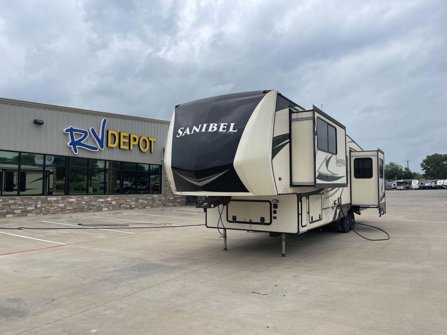 2019 TAN SANIBEL 3702WB (5ZT3SN2B6KG) , located at 4319 N Main St, Cleburne, TX, 76033, (817) 678-5133, 32.385960, -97.391212 - The length of this 2019 Sanibel Fifth Wheel is just over 41 feet, and the width is just over 8 feet. It weighs 11,859 pounds when it's not hitched and 2,298 pounds when it is. The heater in this unit is listed at 40,000 BTUs, and it heats and cools itself automatically. This has a beautiful gray bas - Photo#0