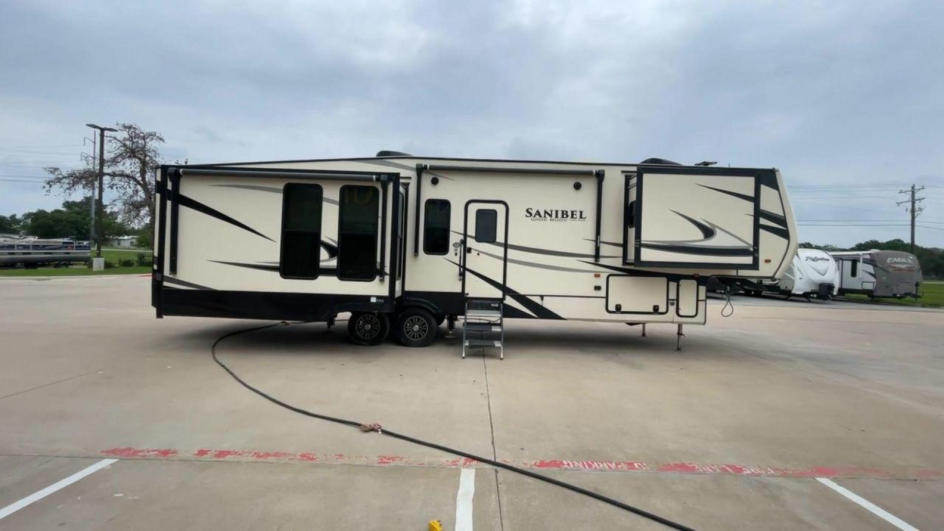 2019 TAN SANIBEL 3702WB (5ZT3SN2B6KG) , located at 4319 N Main St, Cleburne, TX, 76033, (817) 678-5133, 32.385960, -97.391212 - The length of this 2019 Sanibel Fifth Wheel is just over 41 feet, and the width is just over 8 feet. It weighs 11,859 pounds when it's not hitched and 2,298 pounds when it is. The heater in this unit is listed at 40,000 BTUs, and it heats and cools itself automatically. This has a beautiful gray bas - Photo#2