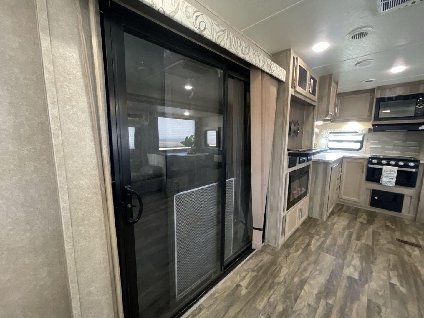 2020 COACHMEN CATALINA 303RKPLE (5ZT2CAVB4LX) , Length: 35.25 ft. | Dry Weight: 7,746 lbs. | Gross Weight: 9,800 lbs. | Slides: 1 transmission, located at 4319 N Main St, Cleburne, TX, 76033, (817) 678-5133, 32.385960, -97.391212 - The 2020 Coachmen Catalina Legacy Edition is a spacious RV with a length of 35.25 feet. Its exteriors feature sleek, silver aluminum siding with blue and black accent decals. The RV has one large slideout that extends the living area. The front of the RV has a rounded nose with a dark rock guard pan - Photo#16