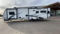 2020 FOREST RIVER FREEDOM EXPRESS (5ZT2FEXBXLW) , Length: 36.92 ft | Dry Weight: 8,328 lbs | Gross Weight: 10,500 lbs | Slides: 3 transmission, located at 4319 N Main St, Cleburne, TX, 76033, (817) 678-5133, 32.385960, -97.391212 - The 2020 Freedom Express 324RLDS has a white body accented with sleek black and blue graphics, creating a stylish look. The front cap features an aerodynamic shape with bold design lines and a large tinted window. A sturdy electric tongue jack is positioned at the hitch for easy adjustments, complem - Photo#6