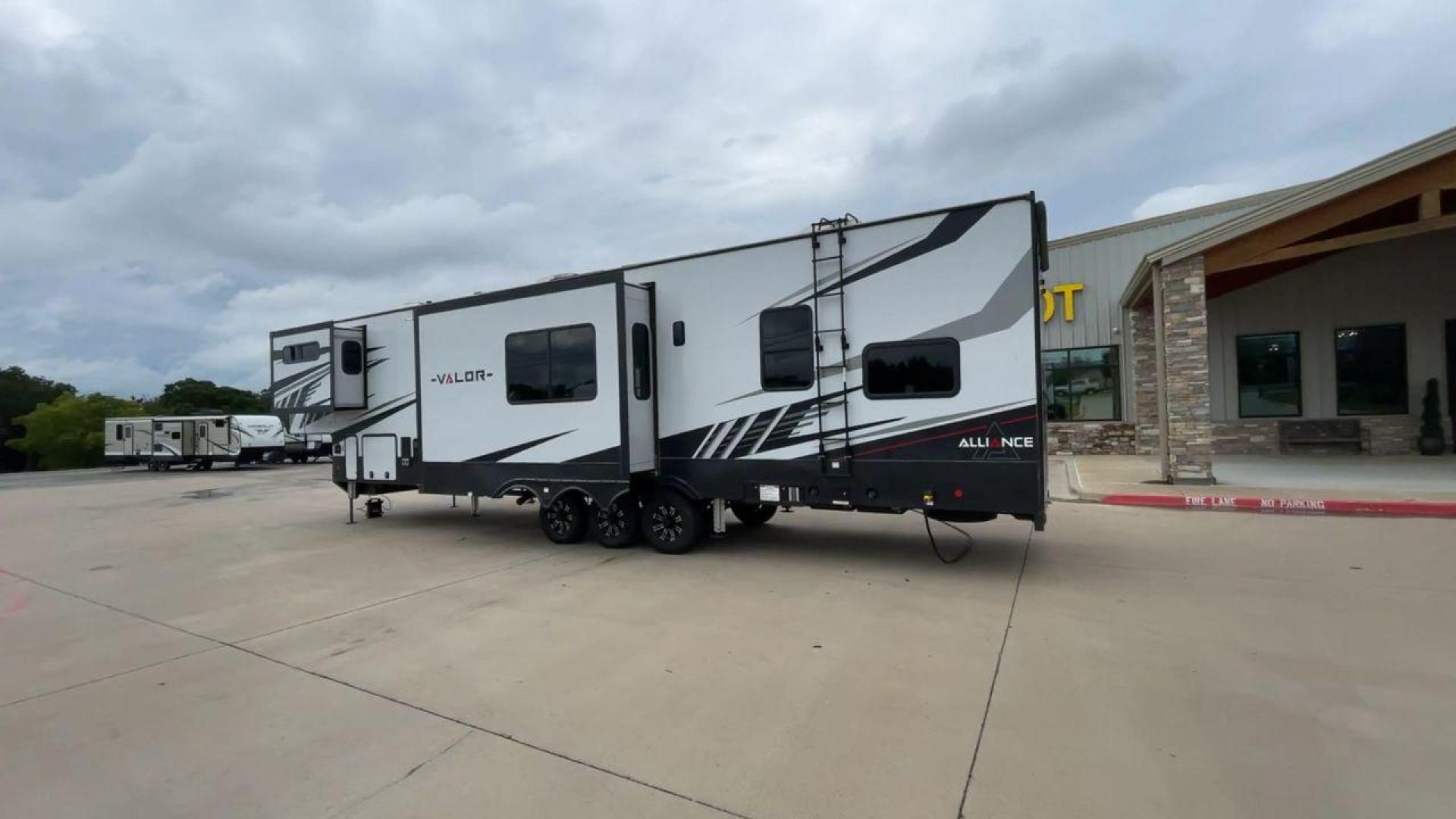 2021 ALLIANCE VALOR 42V13 (7M5FV4533MA) , Length: 44.08 ft. | Dry Weight: 16,064 lbs. | Gross Weight: 20,000 lbs. | Slides: 3 transmission, located at 4319 N Main St, Cleburne, TX, 76033, (817) 678-5133, 32.385960, -97.391212 - The Valor 42V13 features a striking modern exterior with clean lines, highlighted by its sleek black, white, and gray color scheme. The multiple slide-outs (3) enhance interior space, while the large windows offer plenty of natural light. The rear garage entry has a ramp door for easy loading of rec - Photo#7