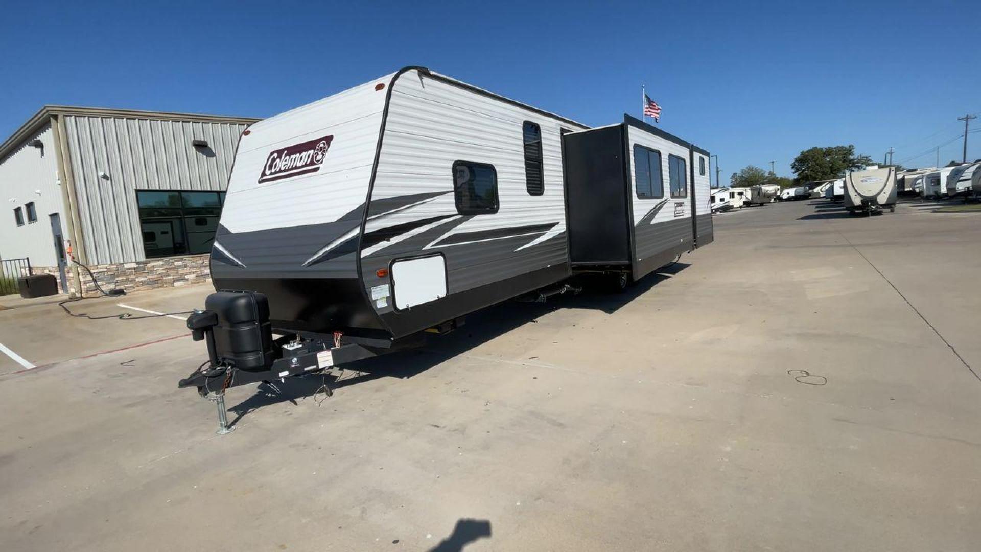 2021 DUTCHMEN COLEMAN 337BH (4YDT33723MH) , Length: 37.92 ft. | Dry Weight: 8,481 lbs. | Slides: 3 transmission, located at 4319 N Main St, Cleburne, TX, 76033, (817) 678-5133, 32.385960, -97.391212 - The 2021 Dutchmen Coleman 337BH, stretching 37.92 feet in length and weighing 8,481 lbs, showcases a sleek exterior designed for functionality and style. With its gray and black color scheme accented by the Coleman branding, this RV has a sturdy, aerodynamic front and a solid frame for durability. T - Photo#5