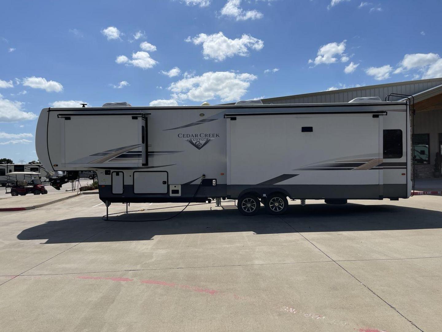 2021 FOREST RIVER CEDAR CREEK 38EL (4X4FCRP25MS) , Length: 39.75 ft. | Dry Weight: 14,429 lbs. | Gross Weight: 18,000 lbs. | Slides: 3 transmission, located at 4319 N Main St, Cleburne, TX, 76033, (817) 678-5133, 32.385960, -97.391212 - The 2021 Forest River Cedar Creek 38EL Champagne offers luxury and space for your next adventure. With a length of 39.75 feet and a dry weight of 14,429 lbs., this RV boasts three spacious slides to maximize living space. The exterior features sleek lines with large windows and a ladder at the rear, - Photo#24