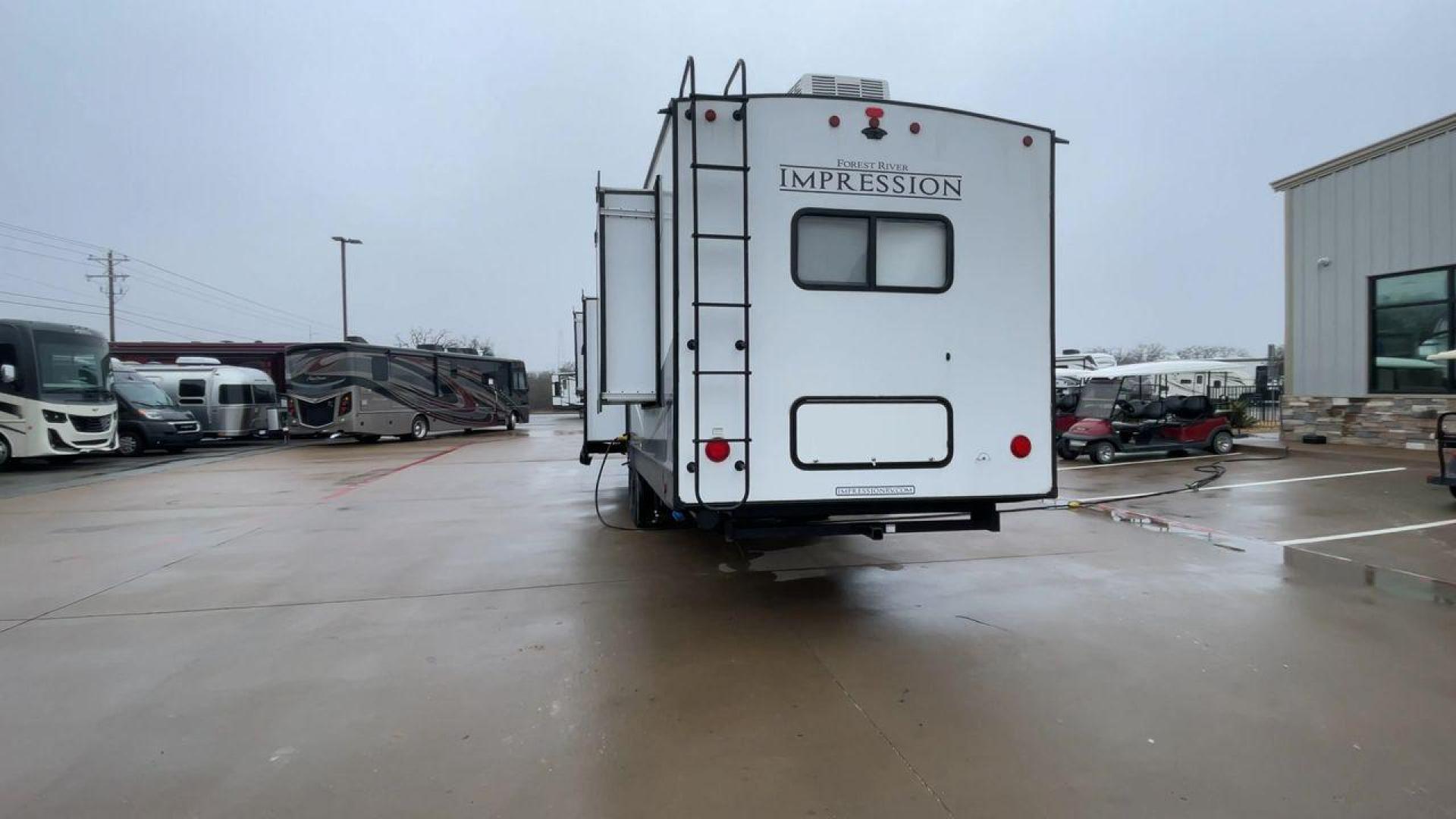 2021 FOREST RIVER IMPRESSION 320FL (5ZT3MPXB1MD) , Length: 40.17 ft | Dry Weight: 10,303 lbs | Gross Weight: 14,535 lbs | Slides: 4 transmission, located at 4319 N Main St, Cleburne, TX, 76033, (817) 678-5133, 32.385960, -97.391212 - The 2021 Forest River Impression 320FL fifth wheel RV is built for durability and style. Its sleek white fiberglass body is accented with bold black and blue graphics, giving it a modern and aerodynamic look. The front cap features a distinctive aerodynamic profile with the Impression logo prominent - Photo#8