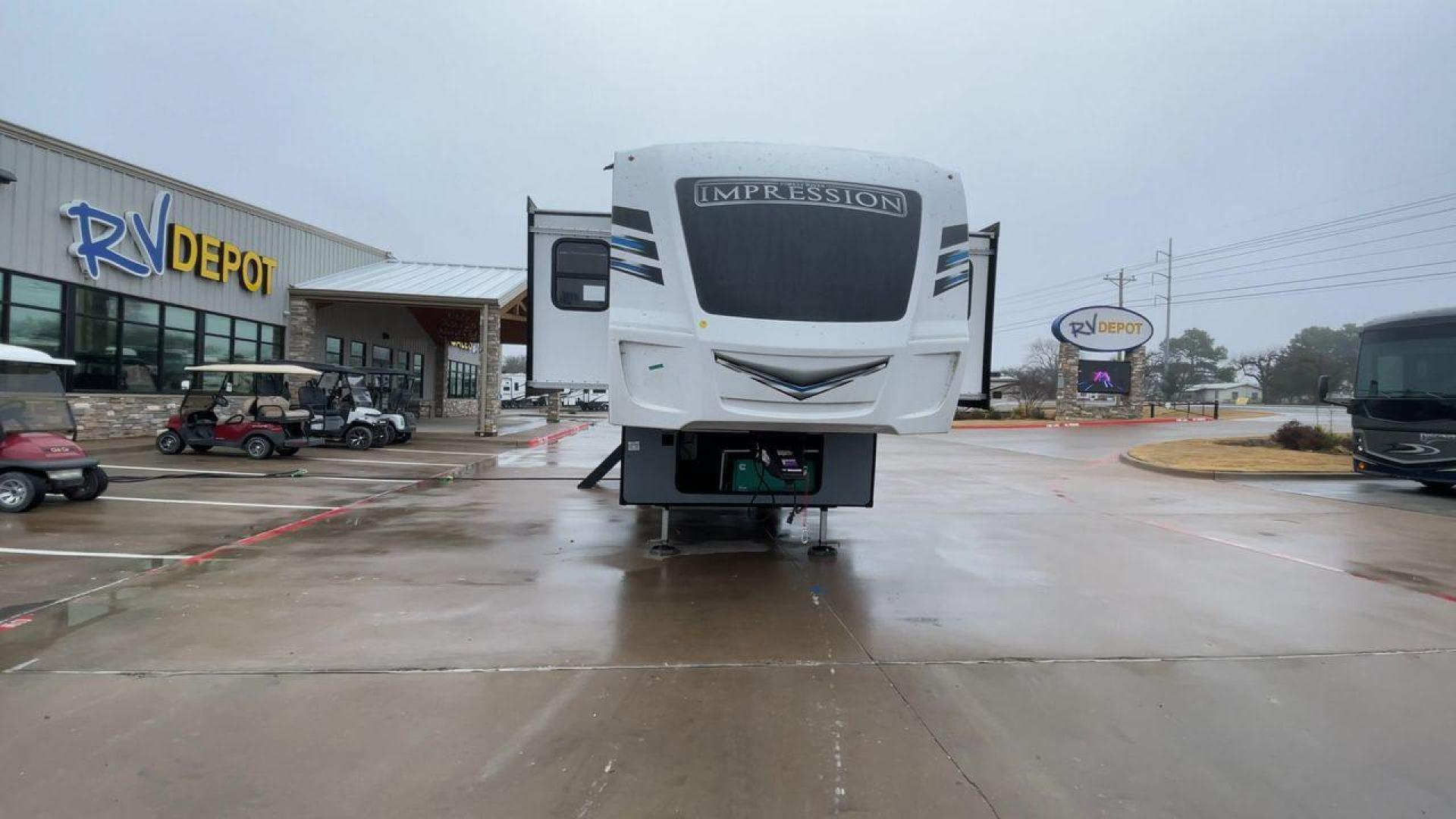 2021 FOREST RIVER IMPRESSION 320FL (5ZT3MPXB1MD) , Length: 40.17 ft | Dry Weight: 10,303 lbs | Gross Weight: 14,535 lbs | Slides: 4 transmission, located at 4319 N Main St, Cleburne, TX, 76033, (817) 678-5133, 32.385960, -97.391212 - The 2021 Forest River Impression 320FL fifth wheel RV is built for durability and style. Its sleek white fiberglass body is accented with bold black and blue graphics, giving it a modern and aerodynamic look. The front cap features a distinctive aerodynamic profile with the Impression logo prominent - Photo#4