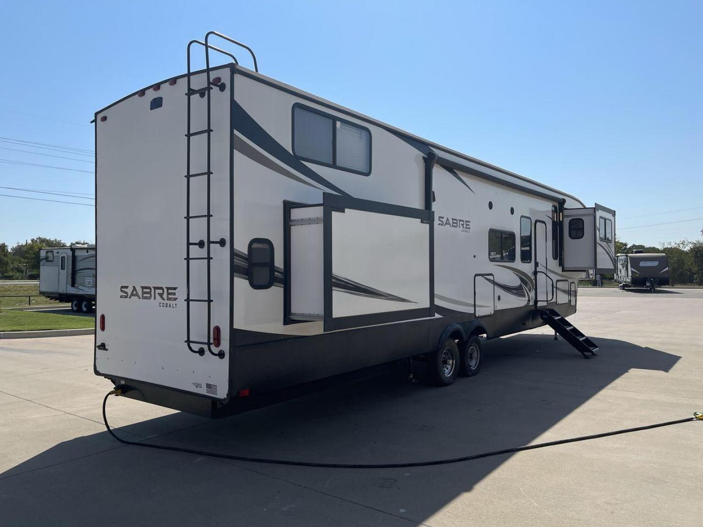 2021 FOREST RIVER SABRE 37FLL (5ZT3SR2B3M6) , Length: 42.75 ft. | Dry Weight: 11,918 lbs. | Slides: 4 transmission, located at 4319 N Main St, Cleburne, TX, 76033, (817) 678-5133, 32.385960, -97.391212 - The 2021 Forest River Sabre 37FLL is a large, luxurious fifth-wheel trailer that measures 42.75 feet in length and features four slide-outs. It has an aerodynamic front cap with the Sabre Cobalt logo and bold, modern graphics. The curved front end is designed to reduce wind drag when towing. The rea - Photo#25