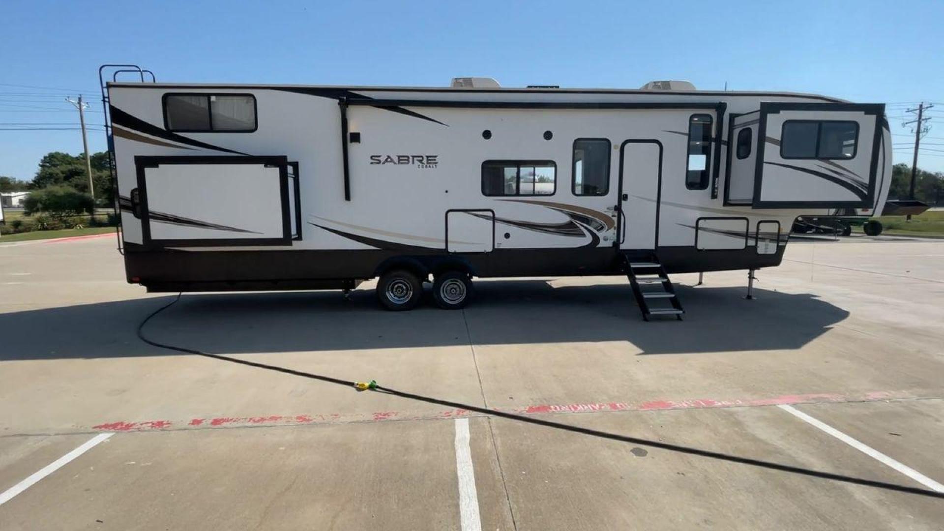 2021 FOREST RIVER SABRE 37FLL (5ZT3SR2B3M6) , Length: 42.75 ft. | Dry Weight: 11,918 lbs. | Slides: 4 transmission, located at 4319 N Main St, Cleburne, TX, 76033, (817) 678-5133, 32.385960, -97.391212 - The 2021 Forest River Sabre 37FLL is a large, luxurious fifth-wheel trailer that measures 42.75 feet in length and features four slide-outs. It has an aerodynamic front cap with the Sabre Cobalt logo and bold, modern graphics. The curved front end is designed to reduce wind drag when towing. The rea - Photo#2