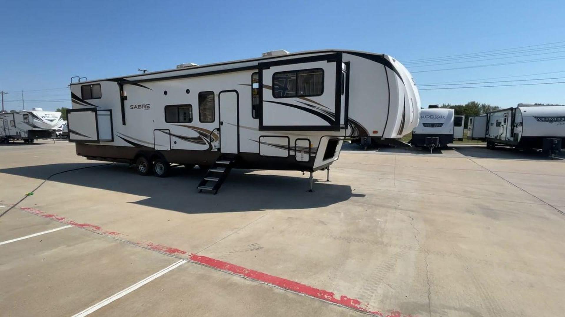 2021 FOREST RIVER SABRE 37FLL (5ZT3SR2B3M6) , Length: 42.75 ft. | Dry Weight: 11,918 lbs. | Slides: 4 transmission, located at 4319 N Main St, Cleburne, TX, 76033, (817) 678-5133, 32.385960, -97.391212 - The 2021 Forest River Sabre 37FLL is a large, luxurious fifth-wheel trailer that measures 42.75 feet in length and features four slide-outs. It has an aerodynamic front cap with the Sabre Cobalt logo and bold, modern graphics. The curved front end is designed to reduce wind drag when towing. The rea - Photo#3