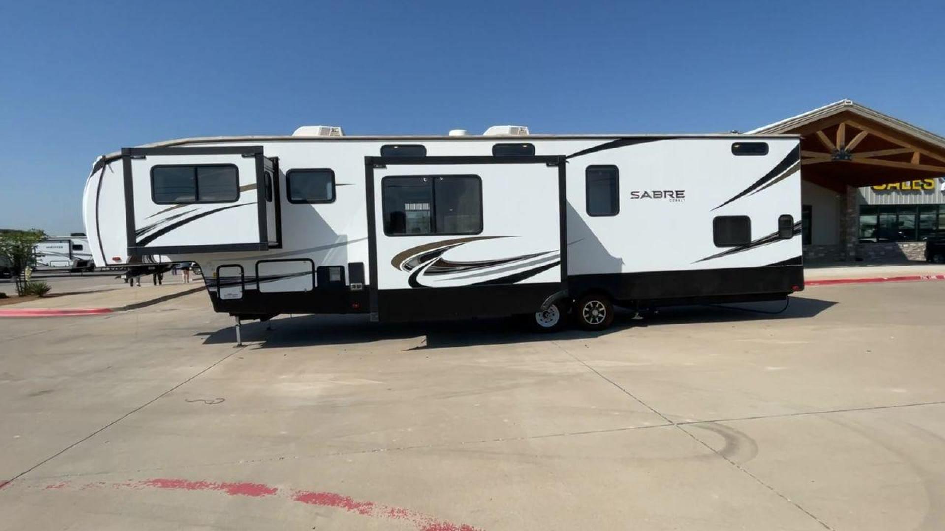 2021 FOREST RIVER SABRE 37FLL (5ZT3SR2B3M6) , Length: 42.75 ft. | Dry Weight: 11,918 lbs. | Slides: 4 transmission, located at 4319 N Main St, Cleburne, TX, 76033, (817) 678-5133, 32.385960, -97.391212 - The 2021 Forest River Sabre 37FLL is a large, luxurious fifth-wheel trailer that measures 42.75 feet in length and features four slide-outs. It has an aerodynamic front cap with the Sabre Cobalt logo and bold, modern graphics. The curved front end is designed to reduce wind drag when towing. The rea - Photo#6