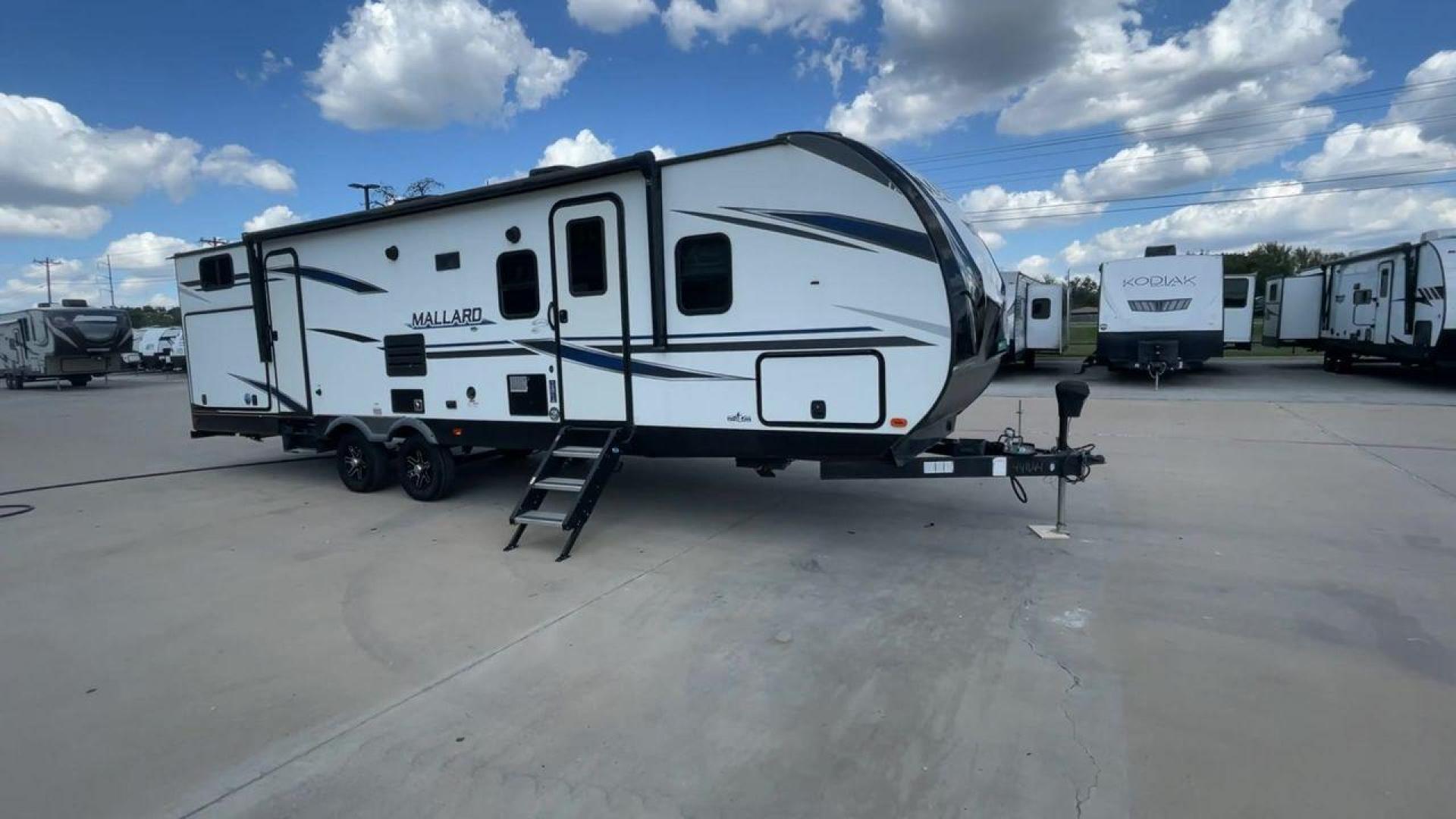 2021 HEARTLAND MALLARD M32 (5SFNB3524ME) , Length: 34.79 ft. | Dry Weight: 6,926 lbs. | Gross Weight: 8,600 lbs. | Slides: 2 transmission, located at 4319 N Main St, Cleburne, TX, 76033, (817) 678-5133, 32.385960, -97.391212 - The 2021 Heartland Mallard M32 is a sleek and modern travel trailer with a length of 34.79 feet and a dry weight of 6,926 lbs. The gross weight is 8,600 lbs, making it easily towable by larger SUVs and trucks. It features a clean, white exterior with stylish blue and black decals that run along the - Photo#3