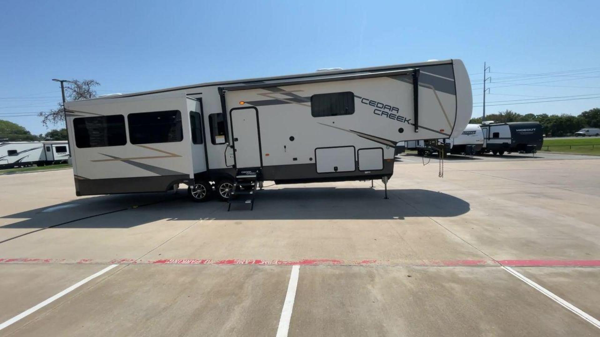 2022 FOREST RIVER CEDAR CREEK 388WDM (4X4FCRR23NS) , Length: 41.5 ft. | Dry Weight: 13,085 lbs. | Slides: 3 transmission, located at 4319 N Main St, Cleburne, TX, 76033, (817) 678-5133, 32.385960, -97.391212 - Photo#2