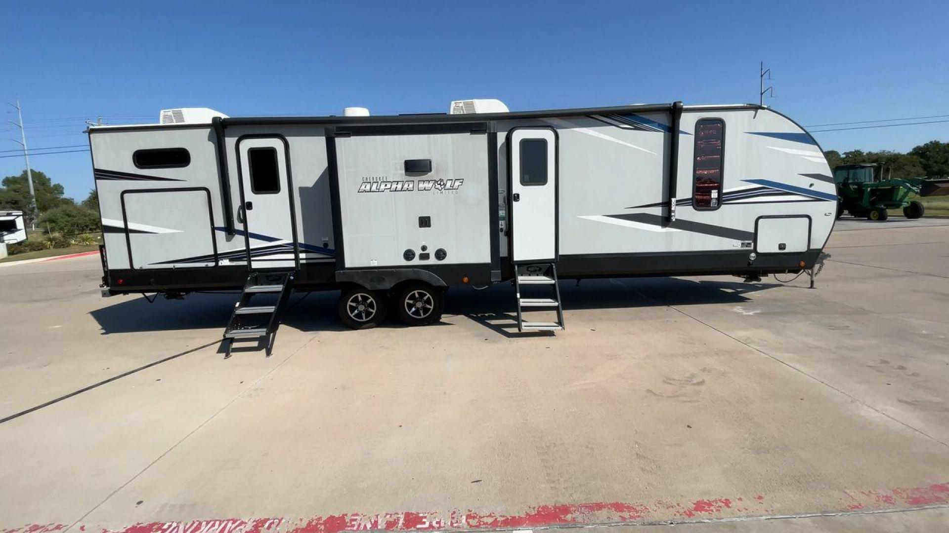 2022 FOREST RIVER CHEROKEE 33BH-L (5ZT2CKYBXN2) , Length: 37.33 ft. | Dry Weight: 7,986 lbs. | Gross Weight: 9,863 lbs. | Slides: 2 transmission, located at 4319 N Main St, Cleburne, TX, 76033, (817) 678-5133, 32.385960, -97.391212 - The 2022 Forest River Cherokee Alpha Wolf 33BH-L showcases a modern and sleek exterior which is perfectly built for extended road adventures. Measuring 37.33 feet in length, it features a two-tone gray and black color scheme with sharp, angular graphics that give it a contemporary, aggressive look. - Photo#2