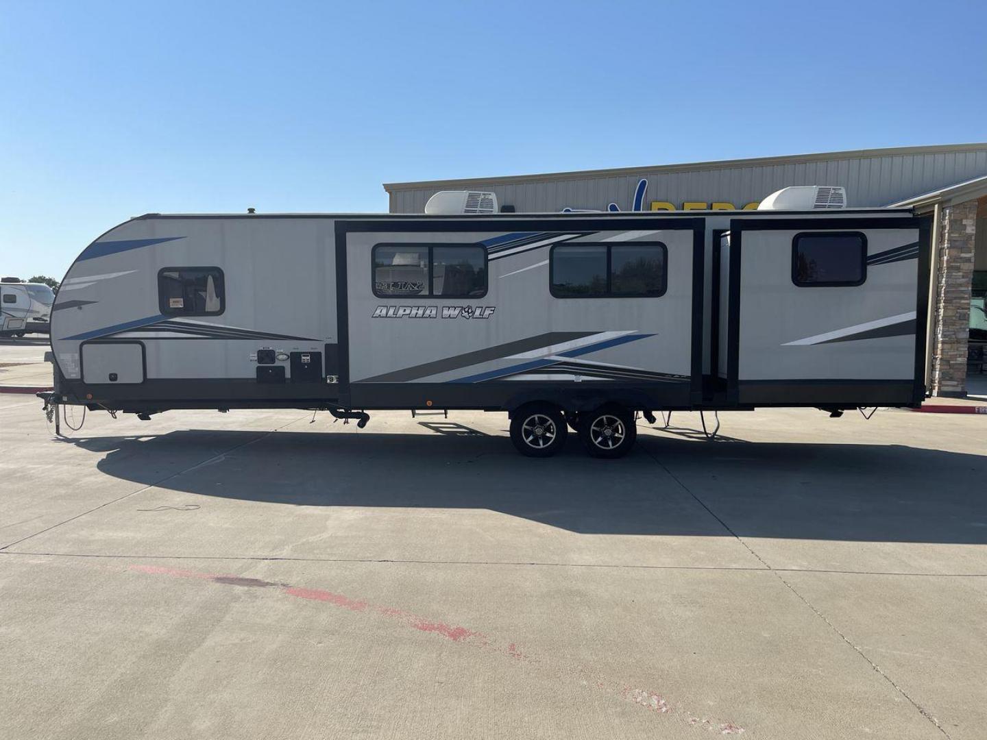 2022 FOREST RIVER CHEROKEE 33BH-L (5ZT2CKYBXN2) , Length: 37.33 ft. | Dry Weight: 7,986 lbs. | Gross Weight: 9,863 lbs. | Slides: 2 transmission, located at 4319 N Main St, Cleburne, TX, 76033, (817) 678-5133, 32.385960, -97.391212 - The 2022 Forest River Cherokee Alpha Wolf 33BH-L showcases a modern and sleek exterior which is perfectly built for extended road adventures. Measuring 37.33 feet in length, it features a two-tone gray and black color scheme with sharp, angular graphics that give it a contemporary, aggressive look. - Photo#24