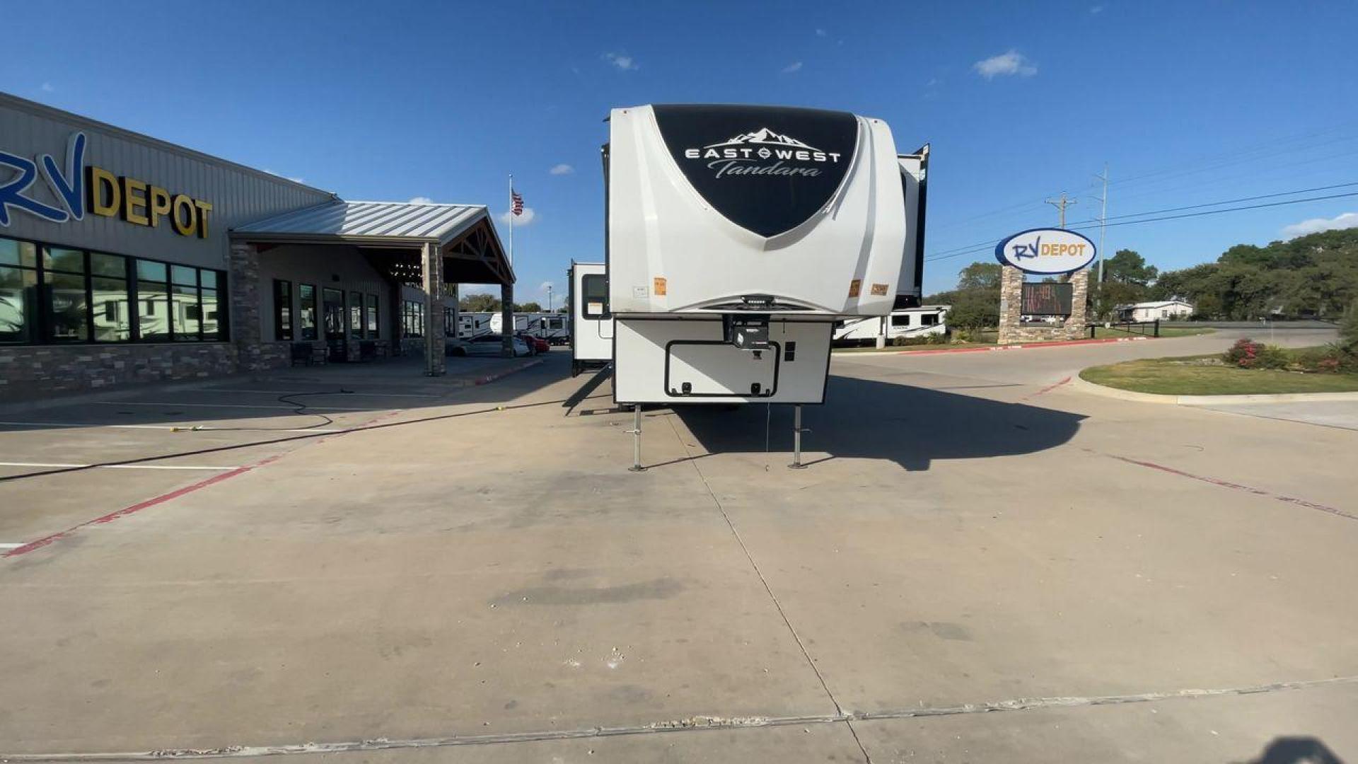 2022 FOREST RIVER EAST TO WEST TANDARA (5ZT3TD4B6N9) , Length: 41.25 ft | Dry Weight: 13,179 lbs | Slides: 4 transmission, located at 4319 N Main St, Cleburne, TX, 76033, (817) 678-5133, 32.385960, -97.391212 - At 41.25 ft. long, the front cap showcases a bold "East to West Tandara" logo, accentuated by clean, aerodynamic curves. Large, tinted windows provide natural light while maintaining privacy. Four (4) slideouts expand the living space, enhancing functionality when parked. The trailer is equipped wit - Photo#4