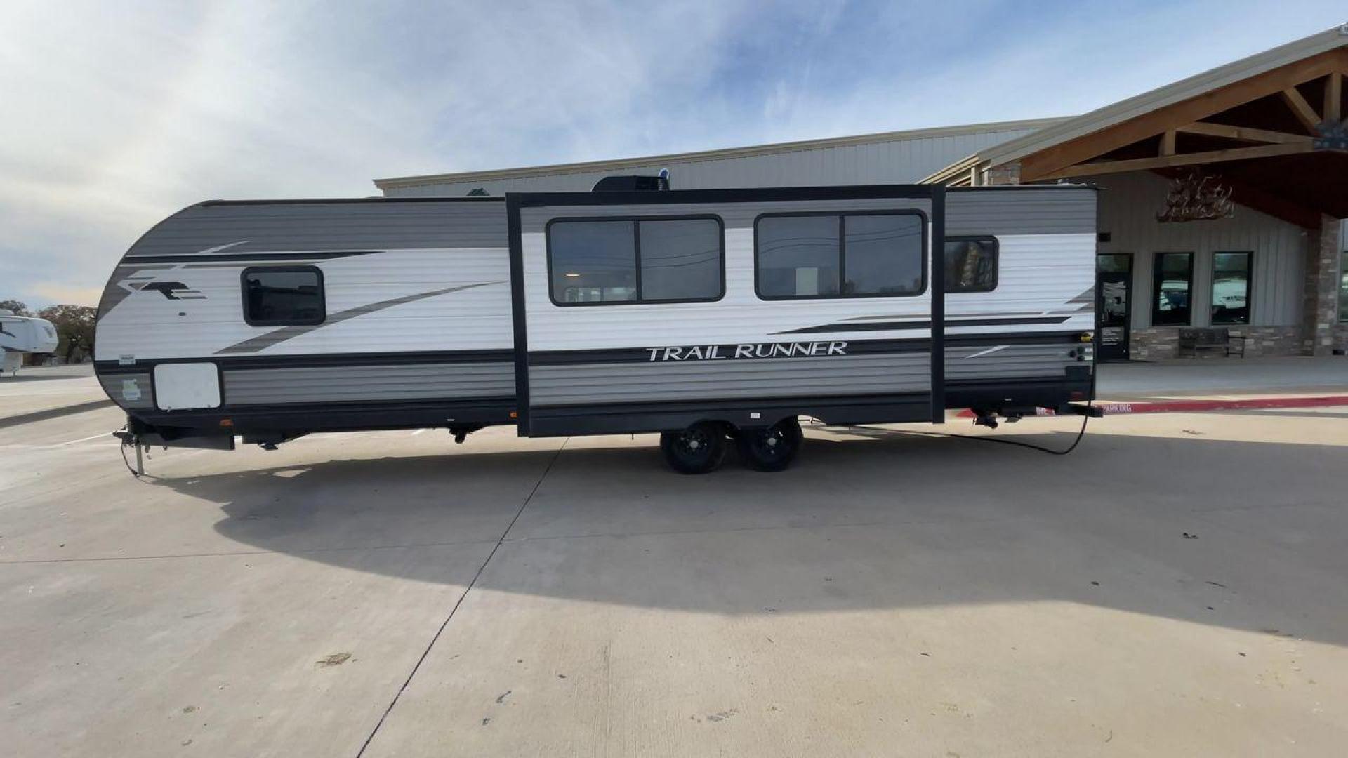 2022 HEARTLAND TRAIL RUNNER 31DB (5SFEB372XNE) , Length: 36.92 ft. | Dry Weight: 7,040 lbs. | Gross Weight: 9,642 lbs. | Slides: 1 transmission, located at 4319 N Main St, Cleburne, TX, 76033, (817) 678-5133, 32.385960, -97.391212 - The 2022 Heartland Trail Runner 31DB has a robust and functional exterior design with modern accents. The front cap of the RV is curved for better aerodynamics, with the bold Trail Runner logo prominently displayed. The front also features a black diamond-plate guard, which offers protection from de - Photo#6