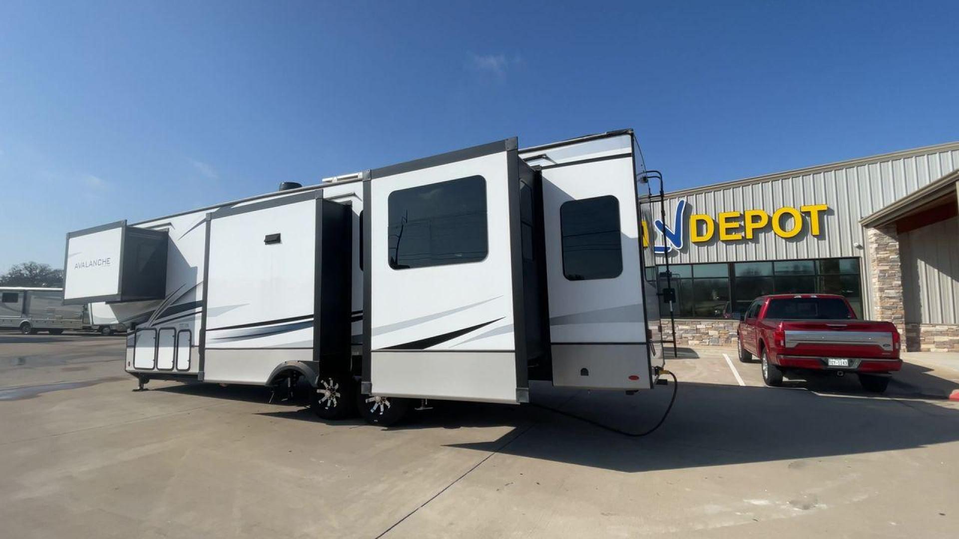 2022 KEYSTONE AVALANCHE 338GK (4YDFAVS24NE) , Length: 38 ft | Dry Weight: 12,523 lbs | Gross Weight: 15,500 lbs | Slides: 4 transmission, located at 4319 N Main St, Cleburne, TX, 76033, (817) 678-5133, 32.385960, -97.391212 - The 2022 Keystone Avalanche 338GK showcases a sleek and modern exterior design, built for durability and style. This fifth wheel features a glossy white body accented by sharp, aerodynamic lines in subtle shades of gray and black, giving it a clean and contemporary look. The front cap is bold and ae - Photo#7