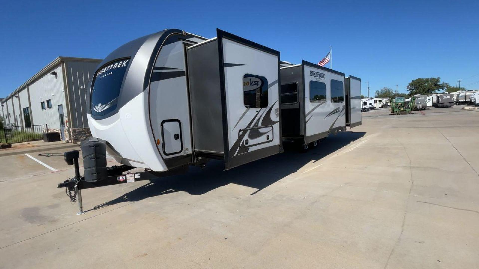 2022 KZ SPORT TREK 343VBH (4EZT13423N8) , Length: 37.67 ft. | Dry Weight: 8,820 lbs. | Slides: 3 transmission, located at 4319 N Main St, Cleburne, TX, 76033, (817) 678-5133, 32.385960, -97.391212 - The 2022 Venture RV Sport Trek 343VBH showcases a sleek and modern exterior with a bright white finish and stylish graphics. It stretches an impressive 37.67 feet. This unit is equipped with a power tongue jack and propane tanks at the front for easy hitching and extended camping capabilities. The s - Photo#5